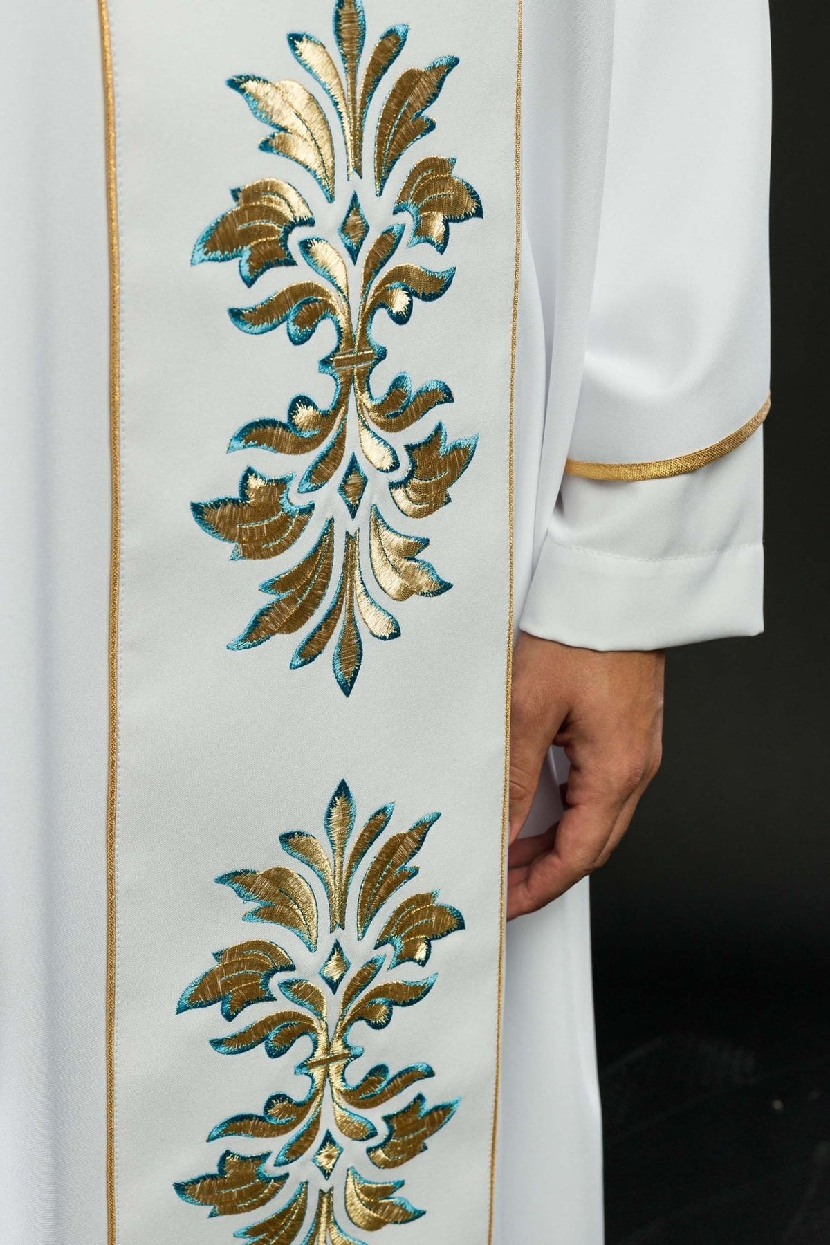 White Marian chasuble, close-up of gold and blue floral embroidered motif with gold trim