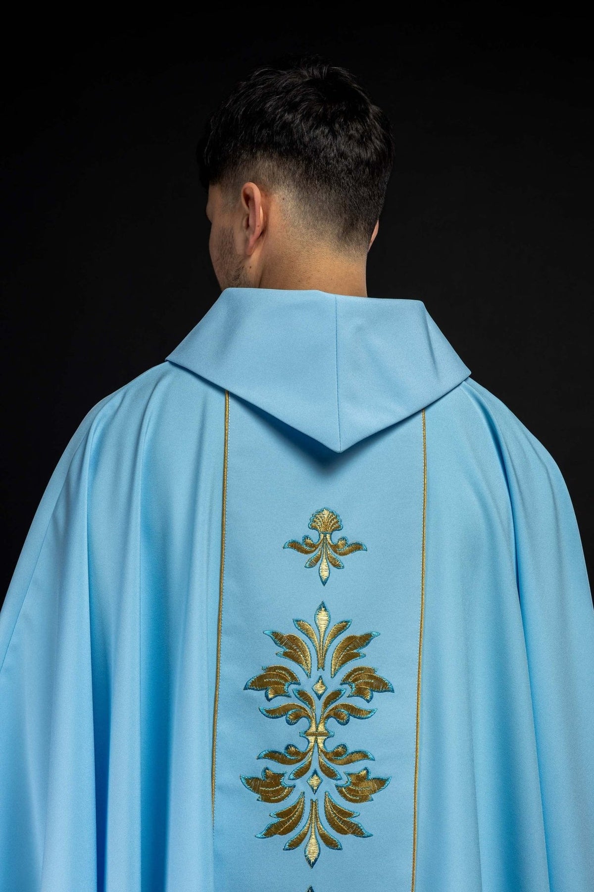 Blue Marian chasuble, back view with central floral embroidery and gold trim