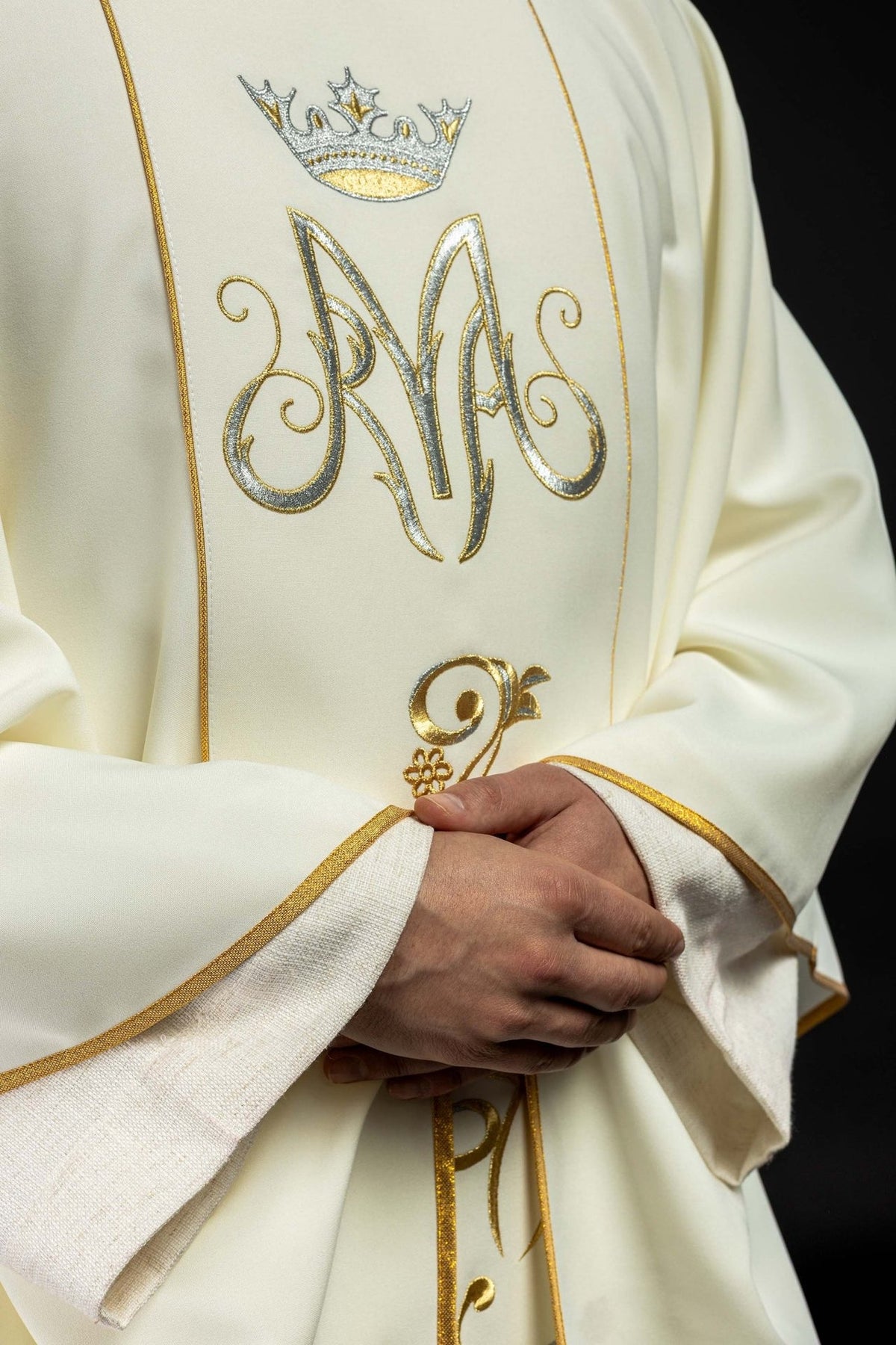 Marian chasuble, angled front view showing gold trim and embroidered Marian motifs