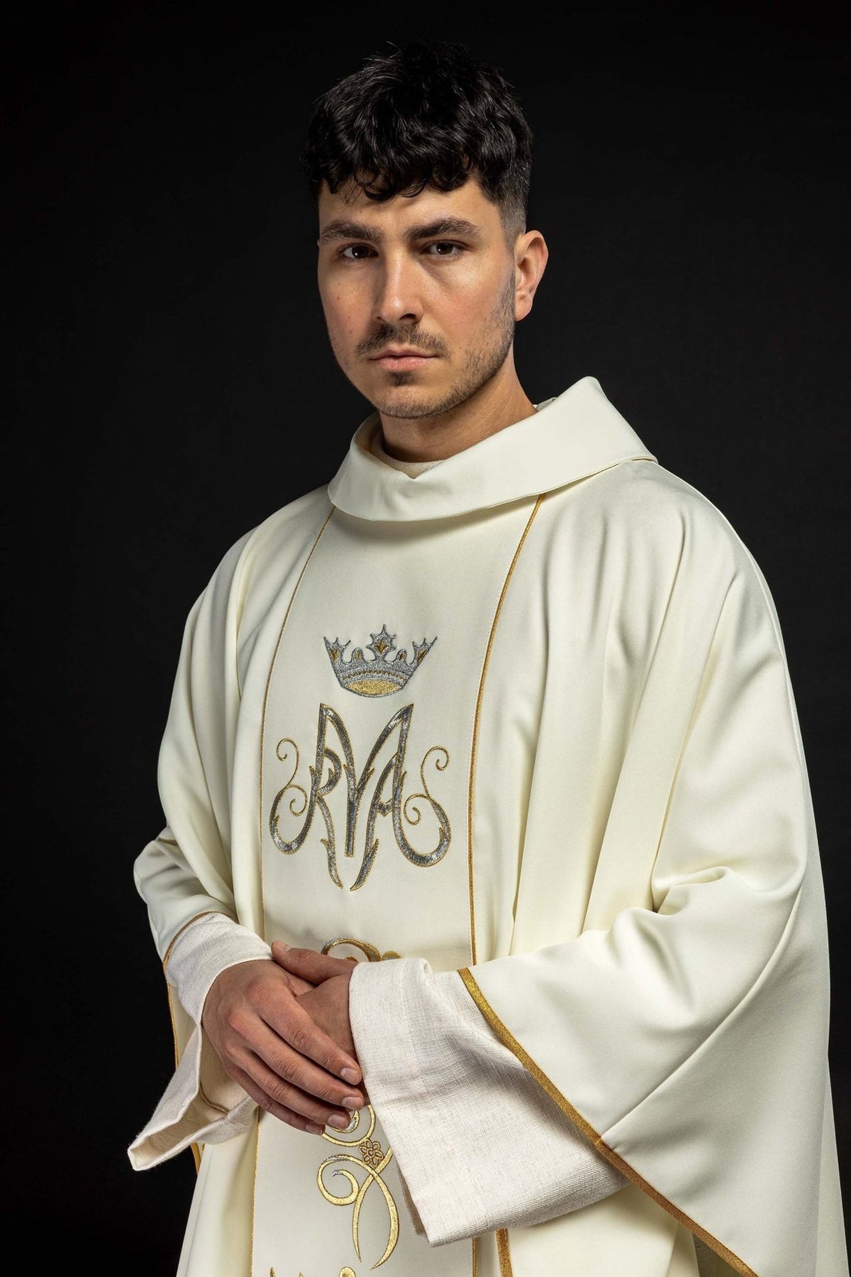Marian chasuble, angled worn front view with Marian monogram and gold-trimmed sleeves