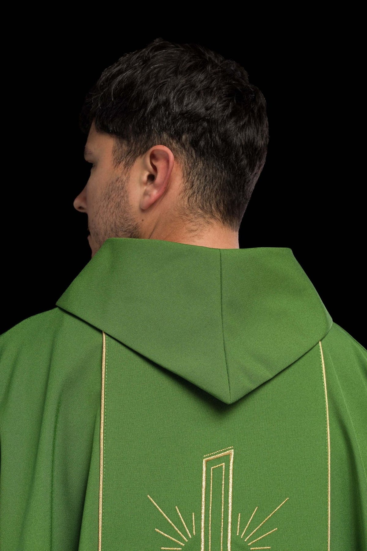 Green chasuble worn front view with gold trim and embroidered orphrey
