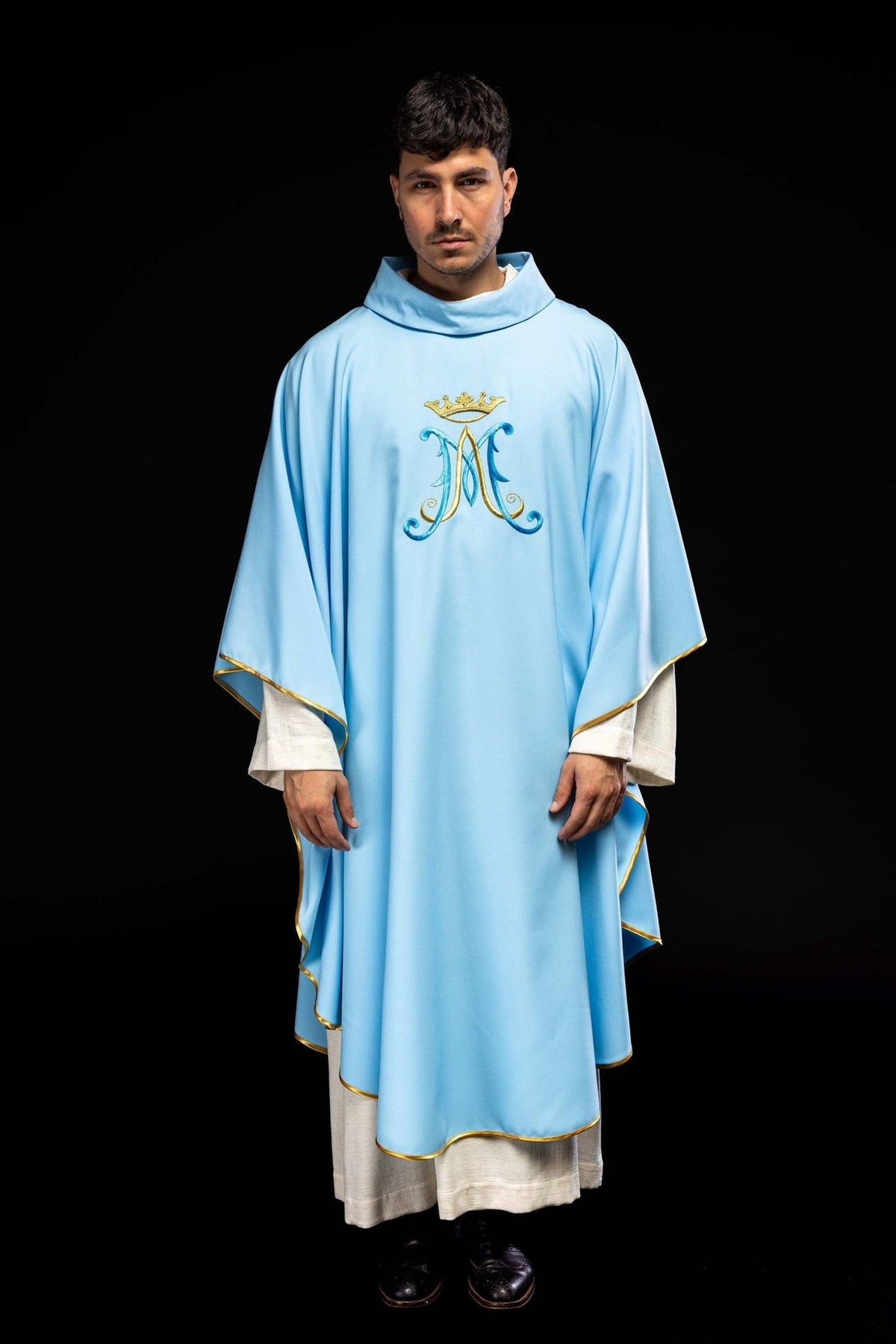 Blue chasuble worn, full front view with embroidered Marian motif and gold trim