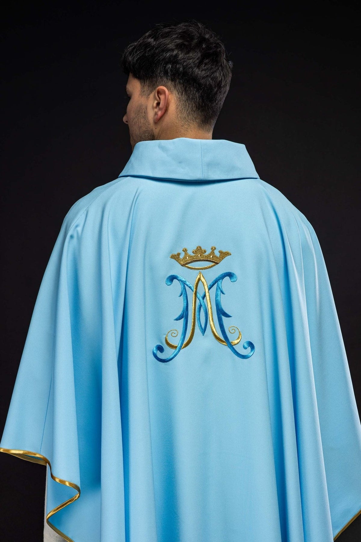 Blue chasuble side detail with gold embroidered cross and Marian motif