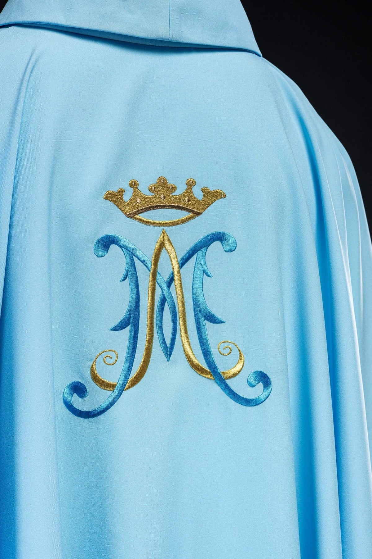 Blue chasuble back view with embroidered Marian motif and gold trim