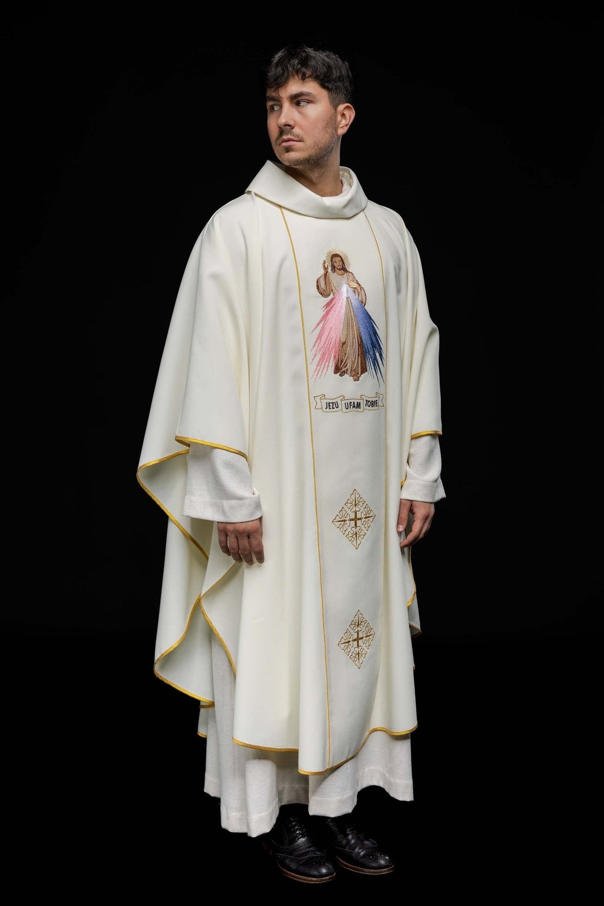 Ecru chasuble worn in front three-quarter view with Divine Mercy embroidery
