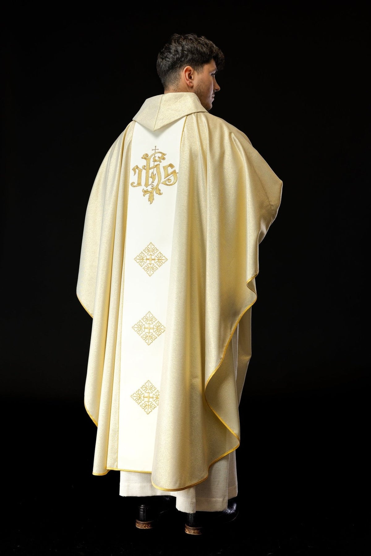 Gold chasuble back view with embroidered IHS and cross motifs