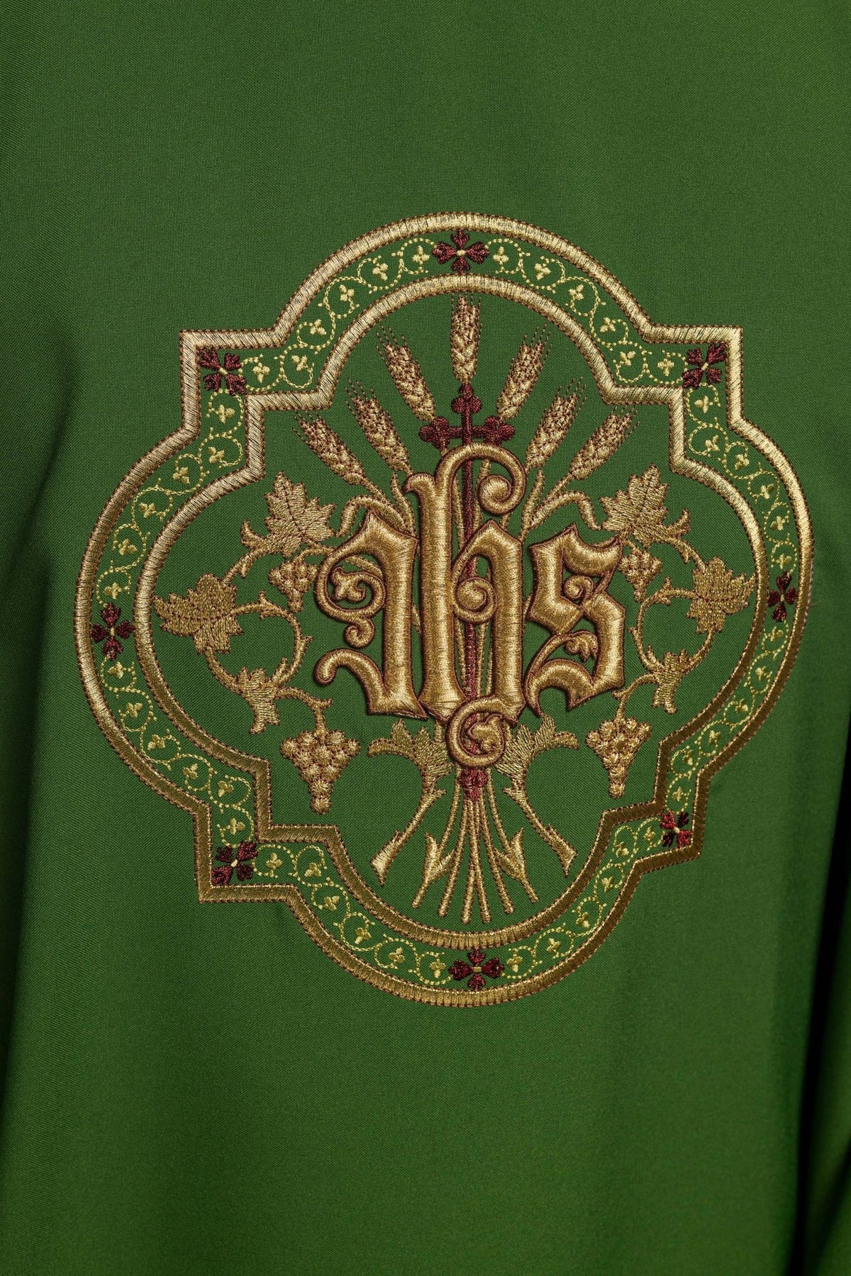 Green chasuble close-up of embroidered IHS, grapes and wheat motif