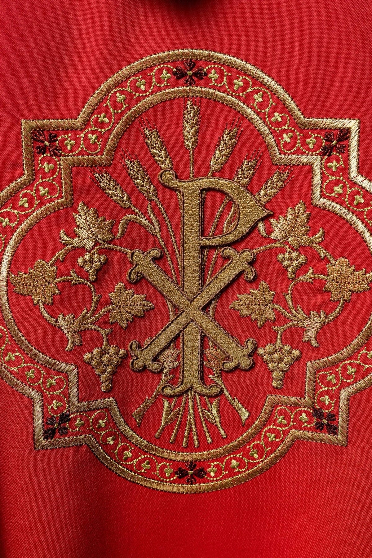 Red chasuble close-up of gold PAX embroidery and ornate border