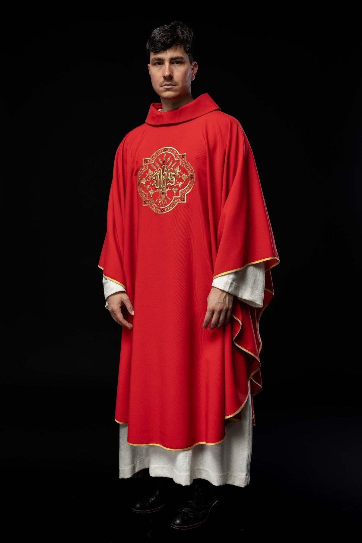 Red chasuble front view with IHS embroidery and gold trim