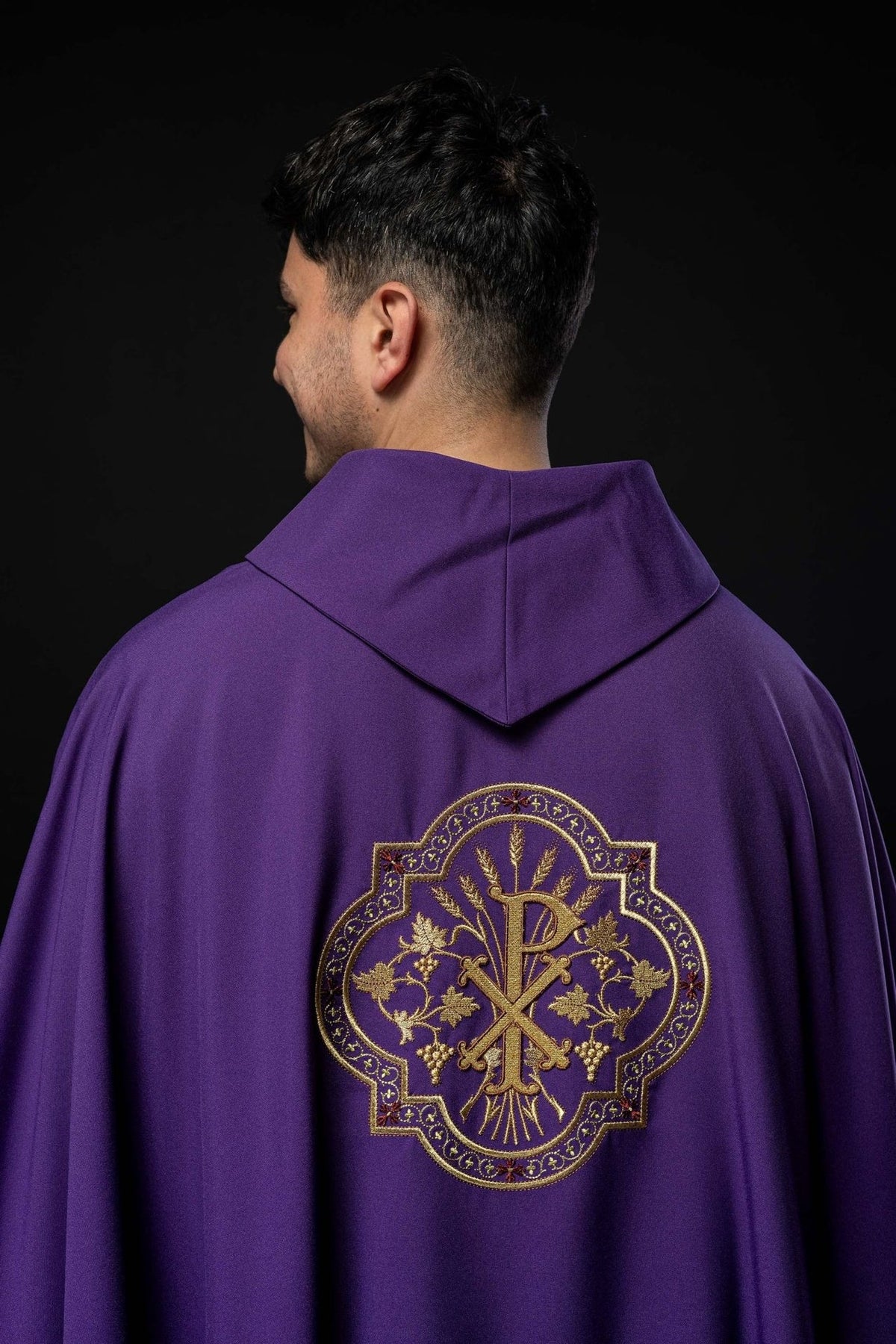 Purple chasuble back view with gold PAX embroidery and stand-up collar