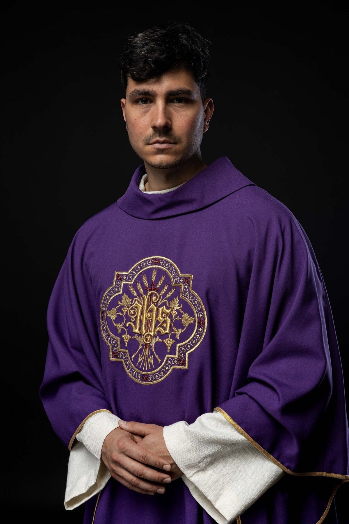 Purple chasuble front view showing the stand-up collar and IHS embroidery