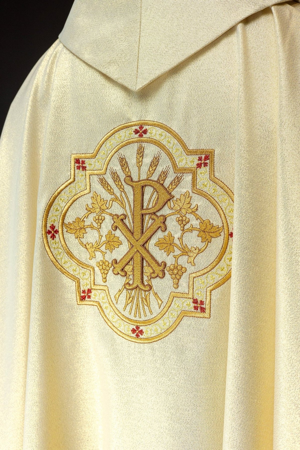 Gold chasuble sleeve close-up with gold trim and embroidered front motif