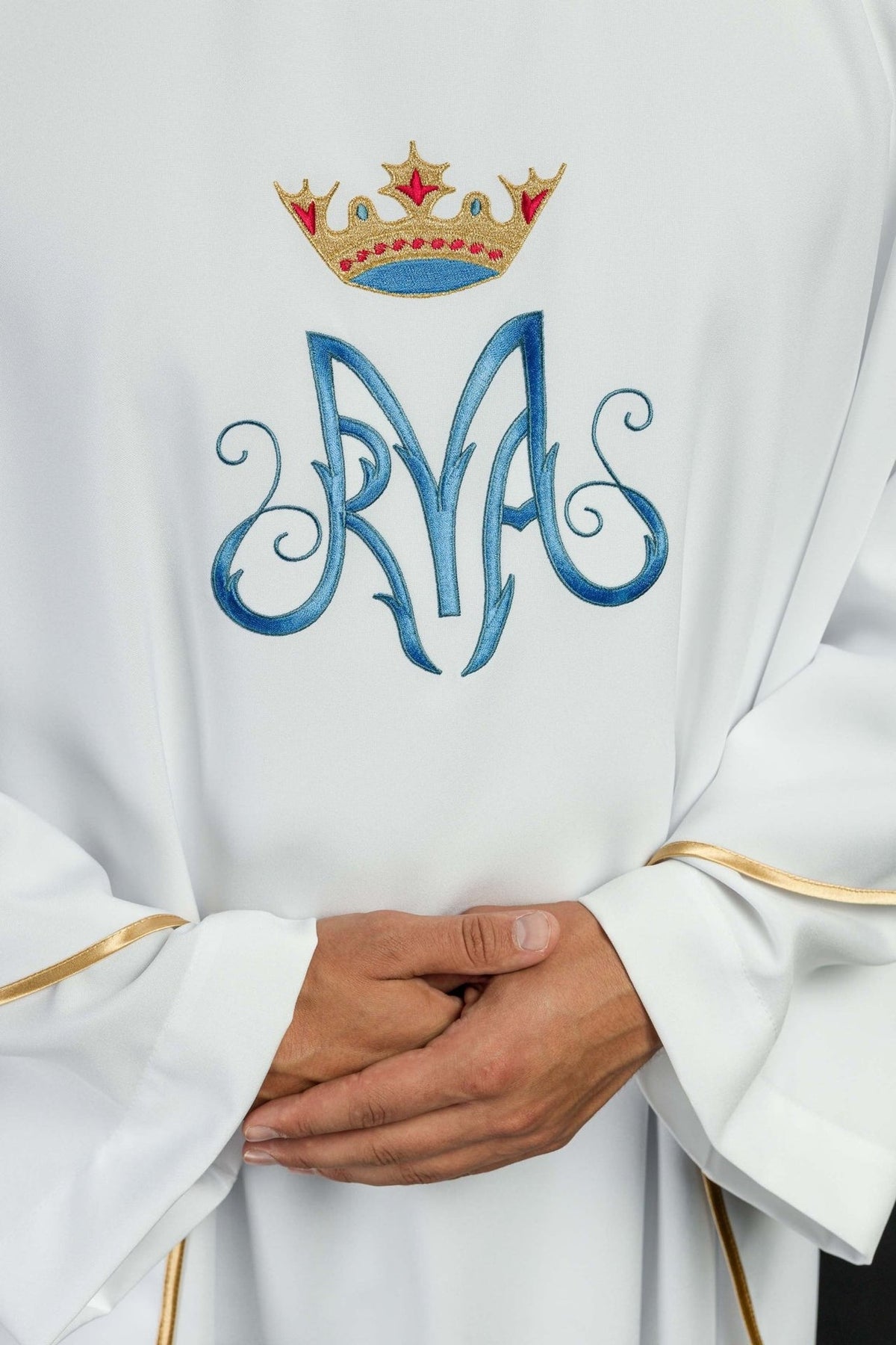 White Marian chasuble front detail showing embroidered Marian monogram, crown and gold trim