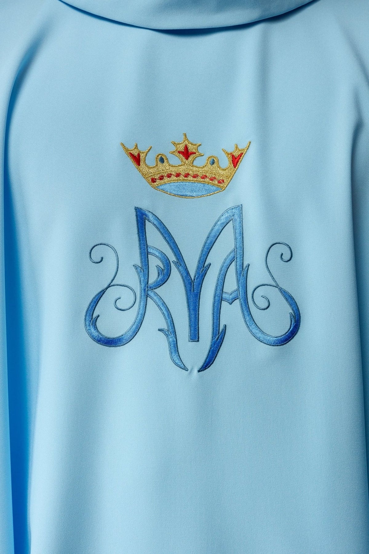 Blue Marian chasuble close-up of crowned Marian symbol embroidery