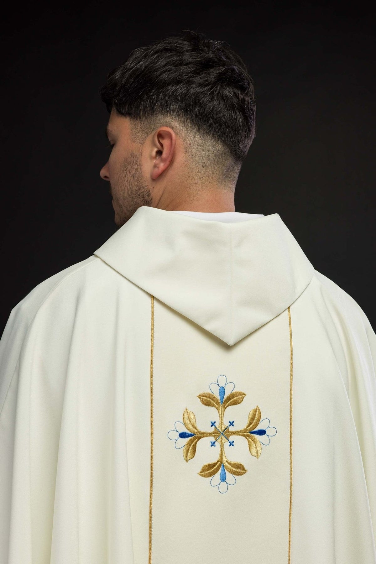 Marian chasuble back view with gold-trimmed orphrey and repeated blue and gold cross motifs