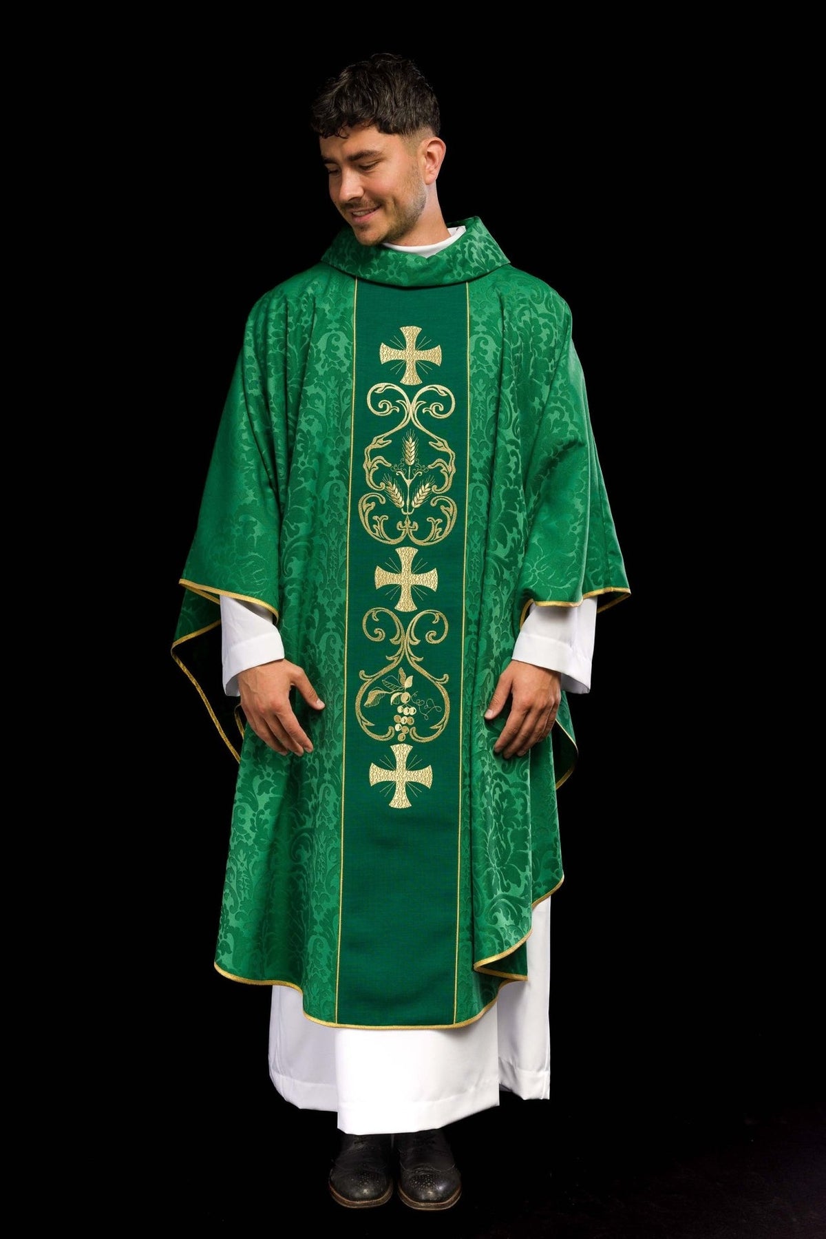 Green chasuble worn from the front, showing the full embroidered orphrey and gold trim