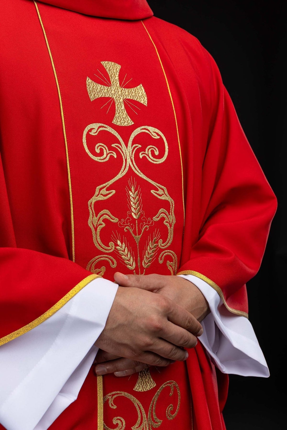 Red chasuble, close-up of gold cross, wheat and scroll embroidery on the orphrey