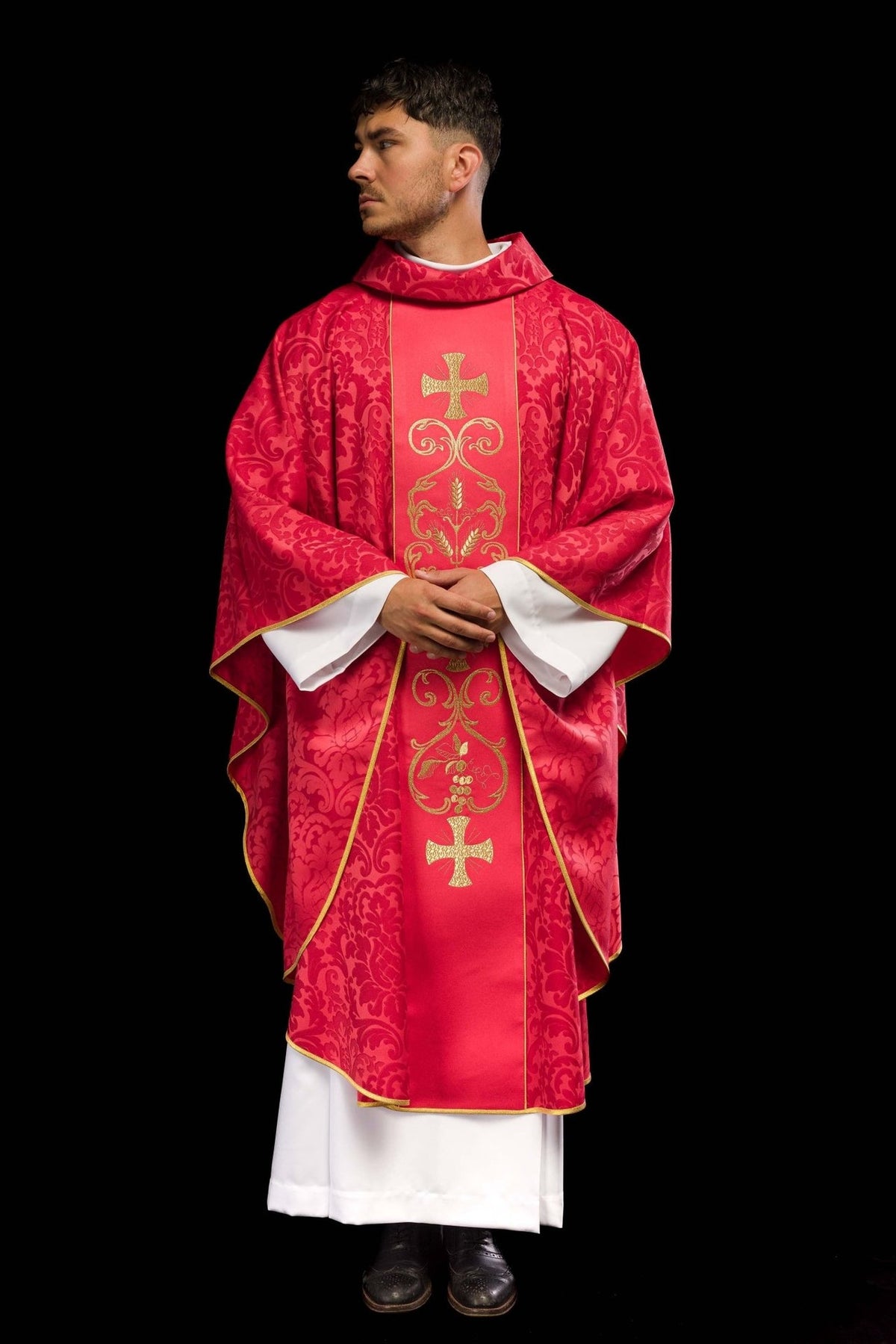 Red chasuble side-front view showing gold trim, stand-up collar and embroidered orphrey