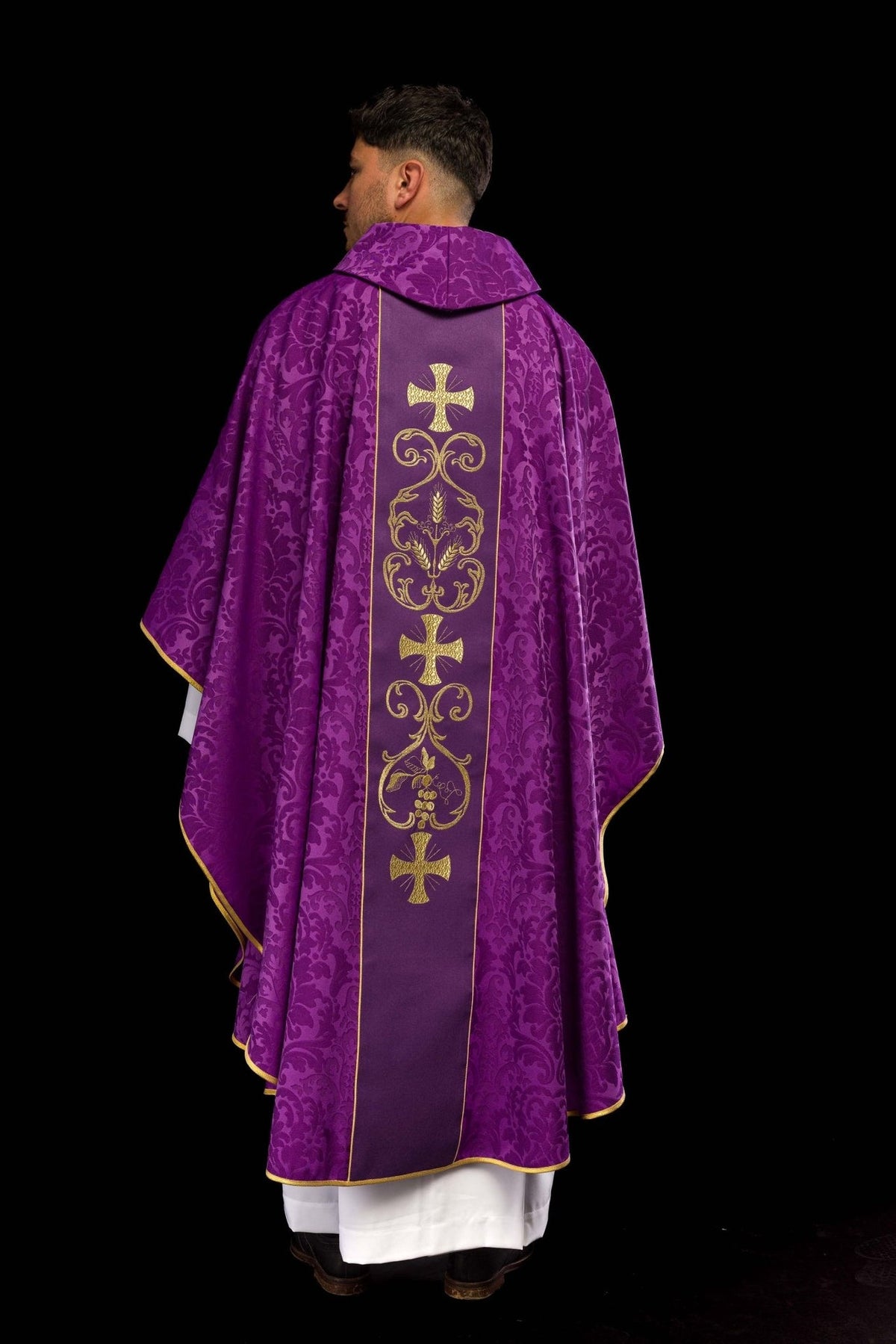 Purple chasuble back view showing full gold embroidered orphrey and jacquard fabric