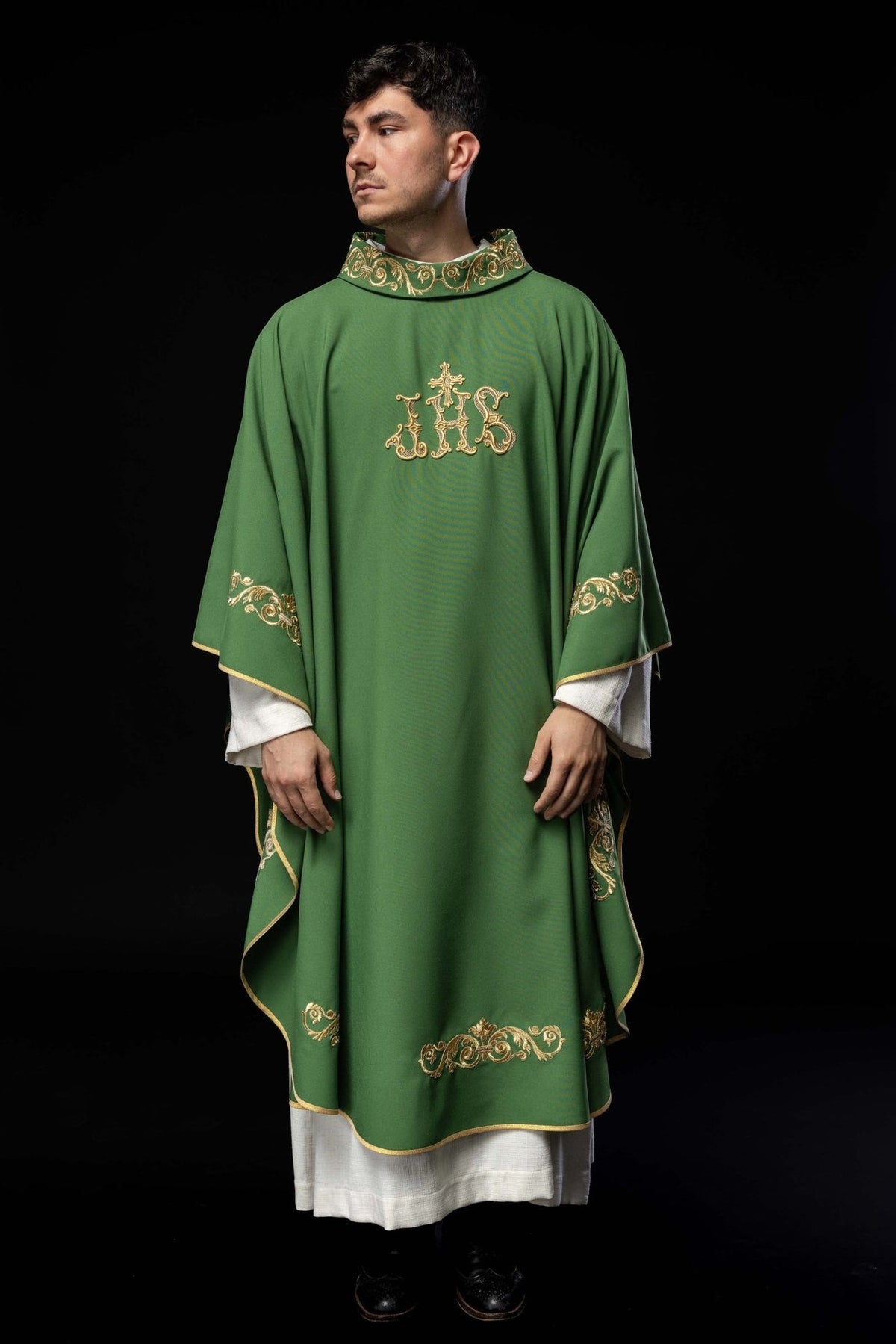 Green chasuble worn in full front view with gold IHS embroidery and trim