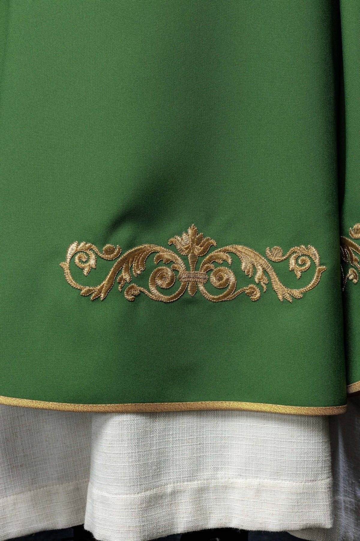Green chasuble close-up showing embroidered stand-up collar