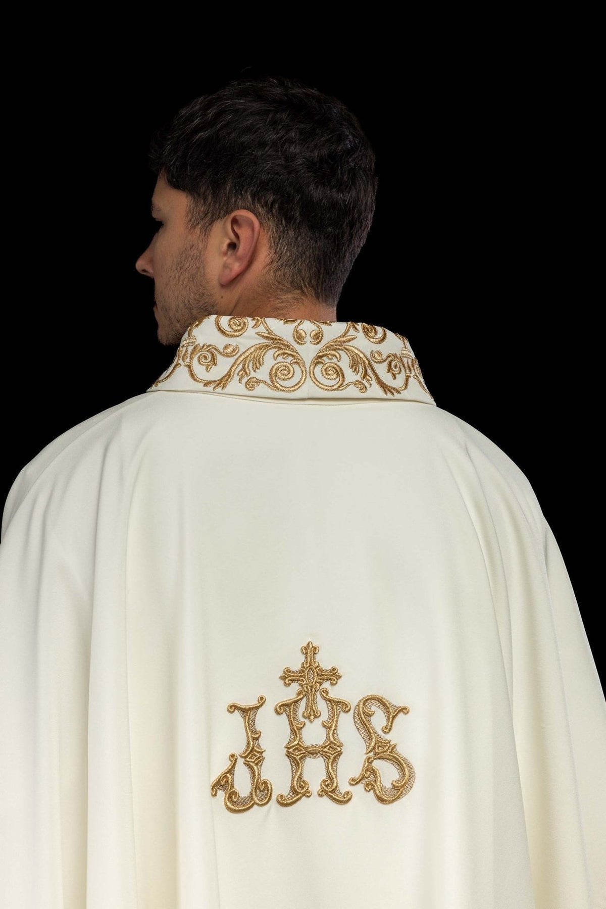 Ivory chasuble back view with gold IHS embroidery and decorative collar trim