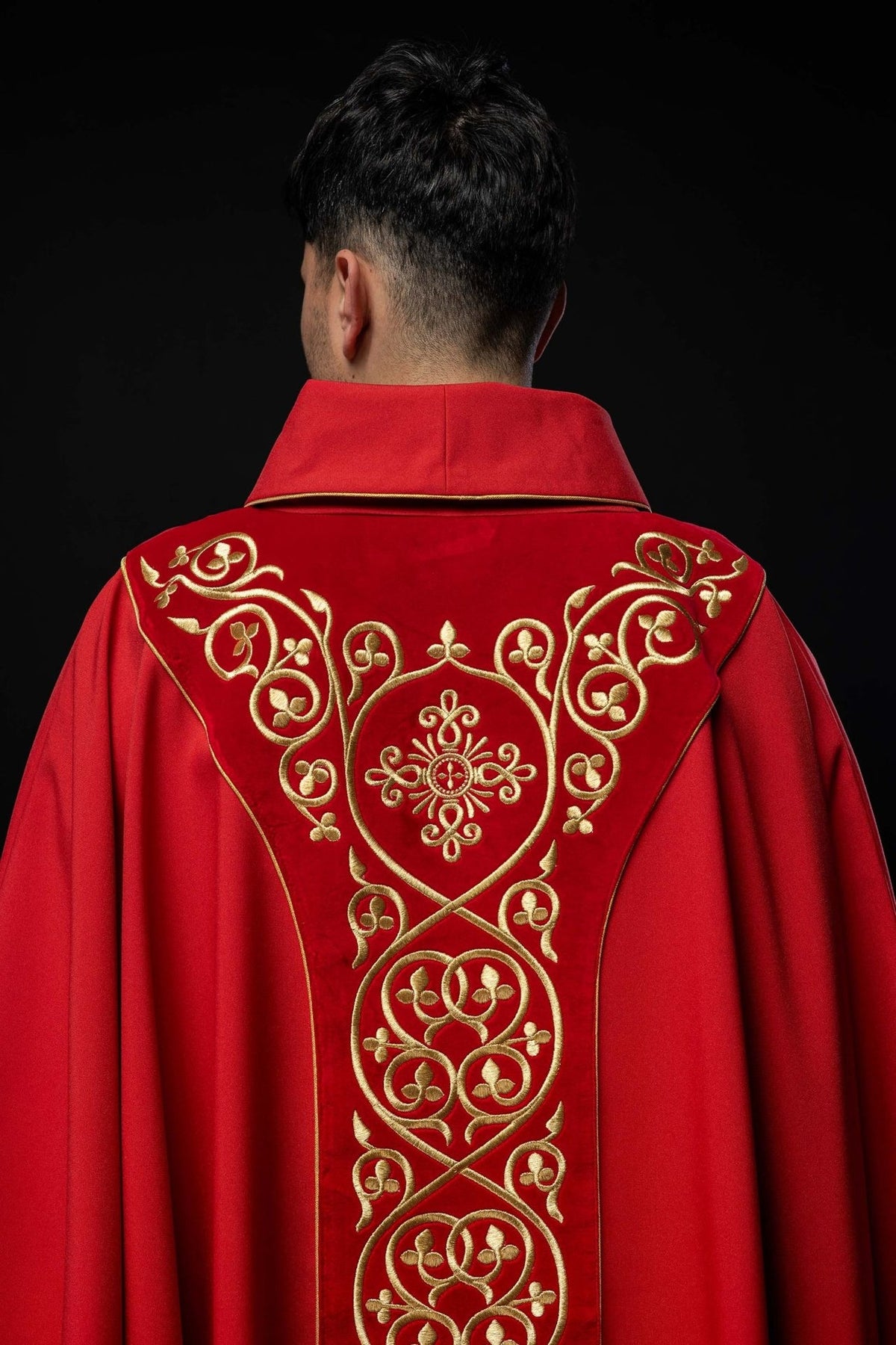 Red chasuble back close-up with gold embroidered orphrey and stand-up collar