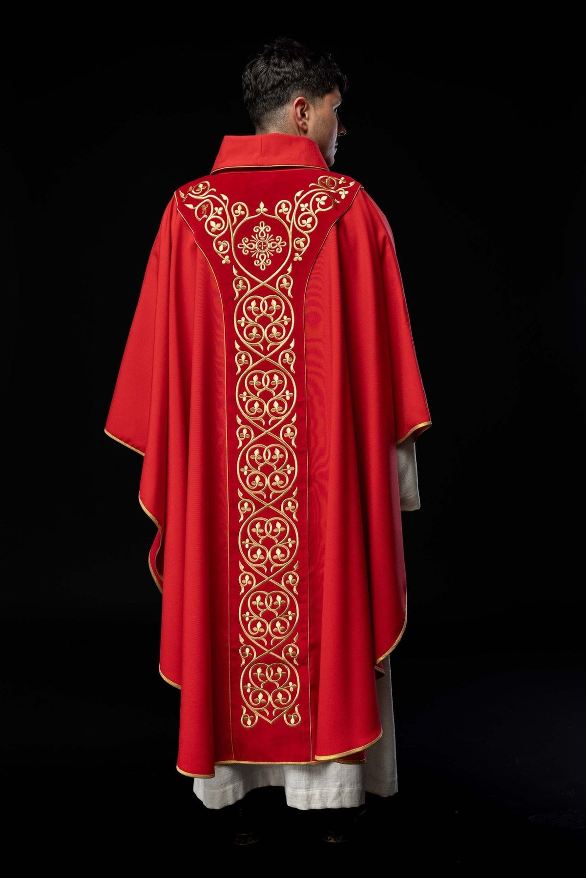 Red chasuble back view with full-length gold embroidered orphrey