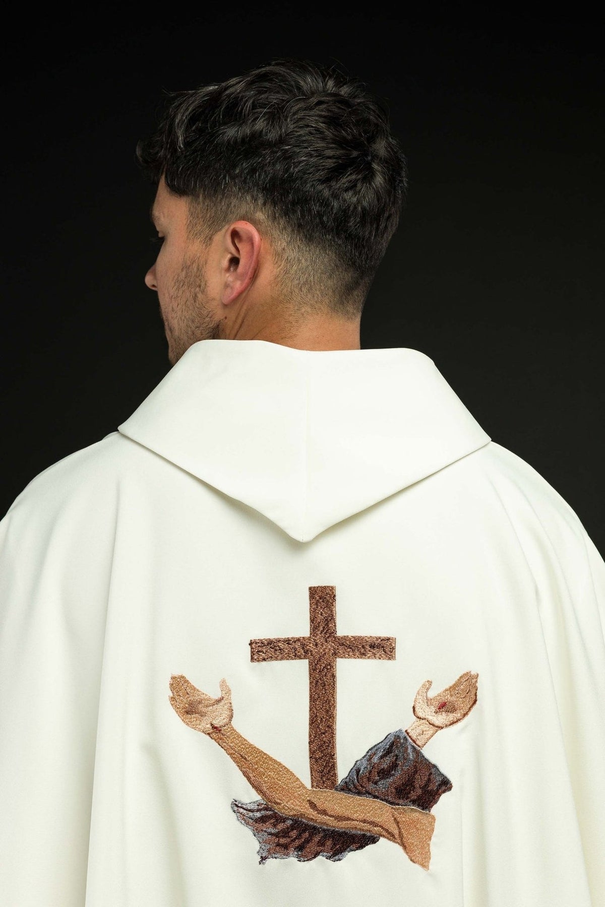 White chasuble back view with embroidered brown cross and crossed Franciscan arms