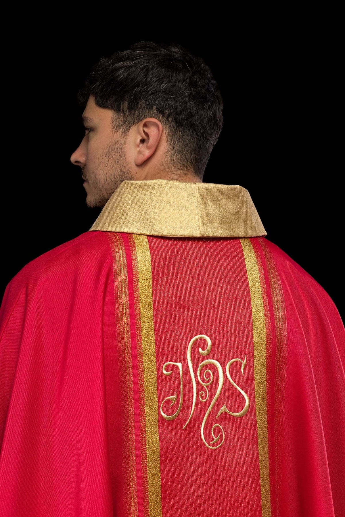 Red chasuble back close-up with gold stand-up collar and embroidered IHS design