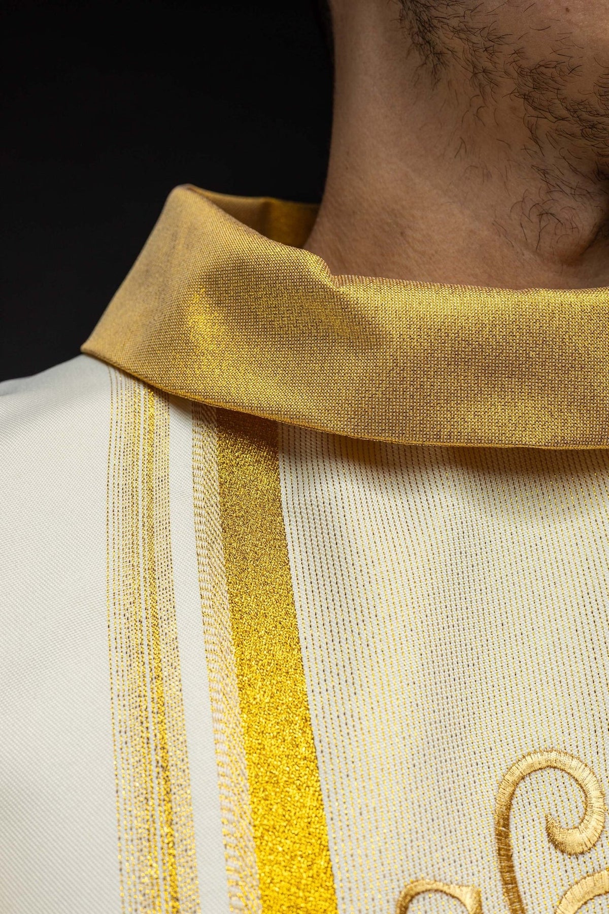 Chasuble detail showing gold trim along the sleeve edge