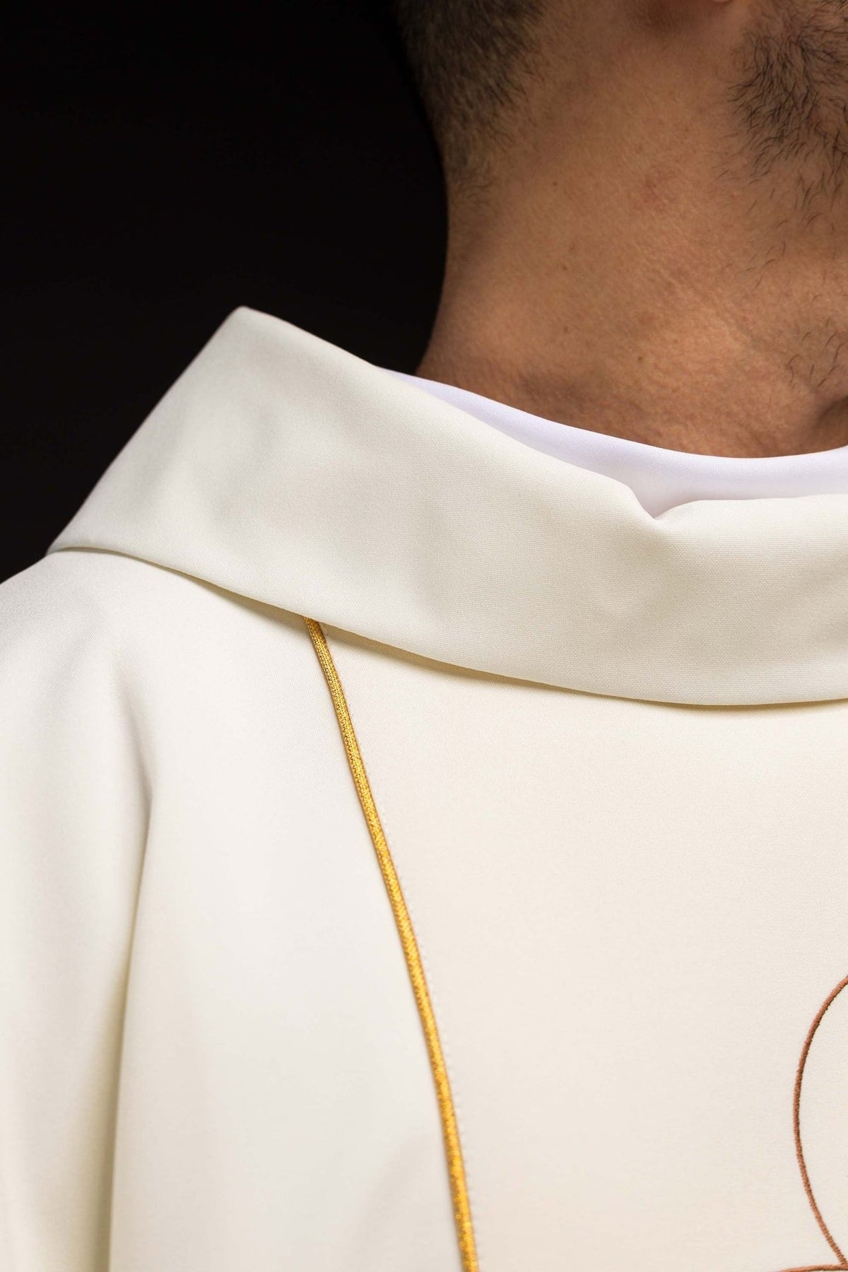 Holy Family chasuble, close-up of embroidered image and gold-edged sleeve