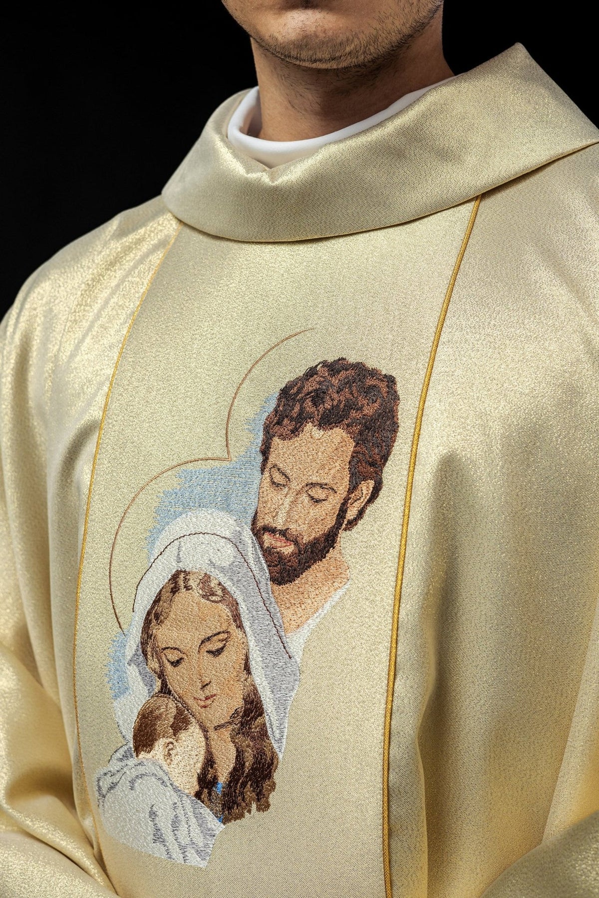 Gold chasuble close-up showing stand-up collar and embroidered Holy Family