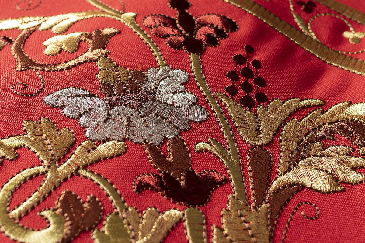 Red Roman chasuble close-up showing embroidered multicolour floral motifs