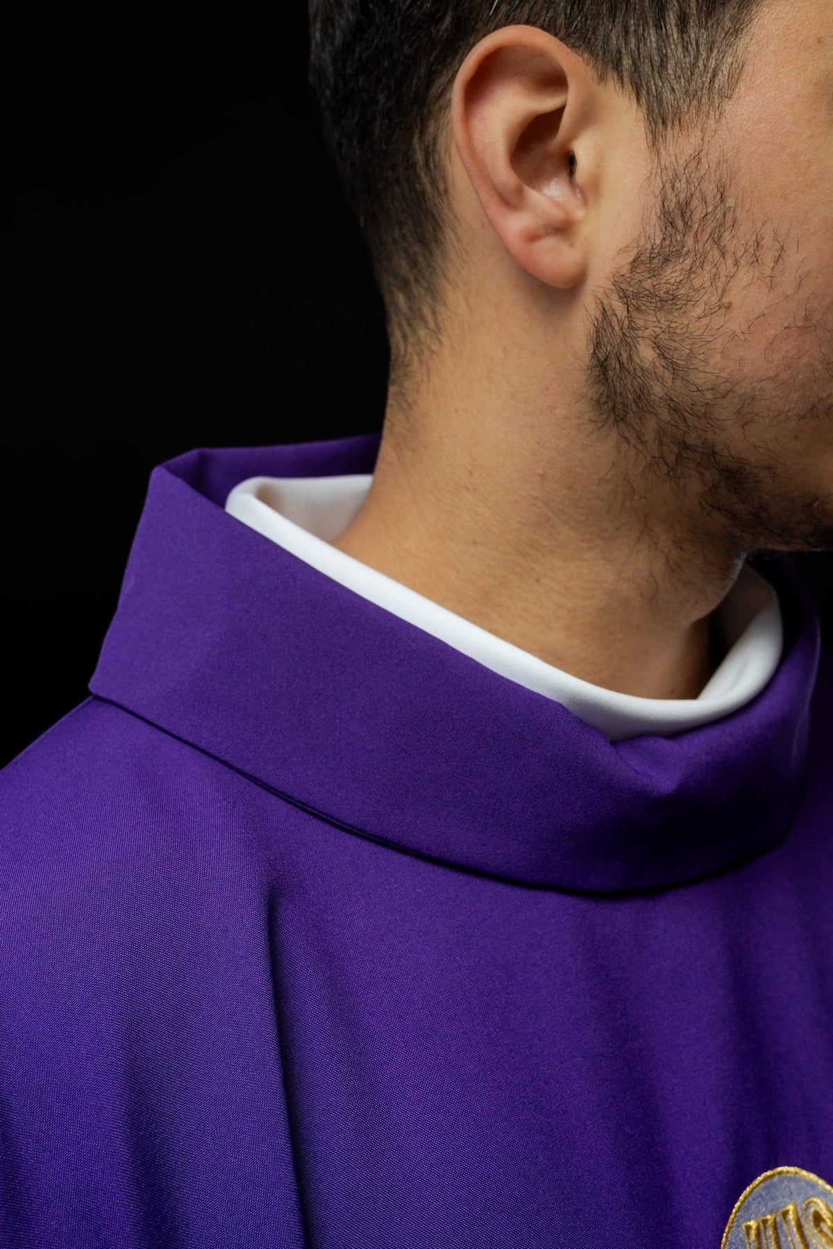 Purple chasuble sleeve close-up with gold trim and satin lining