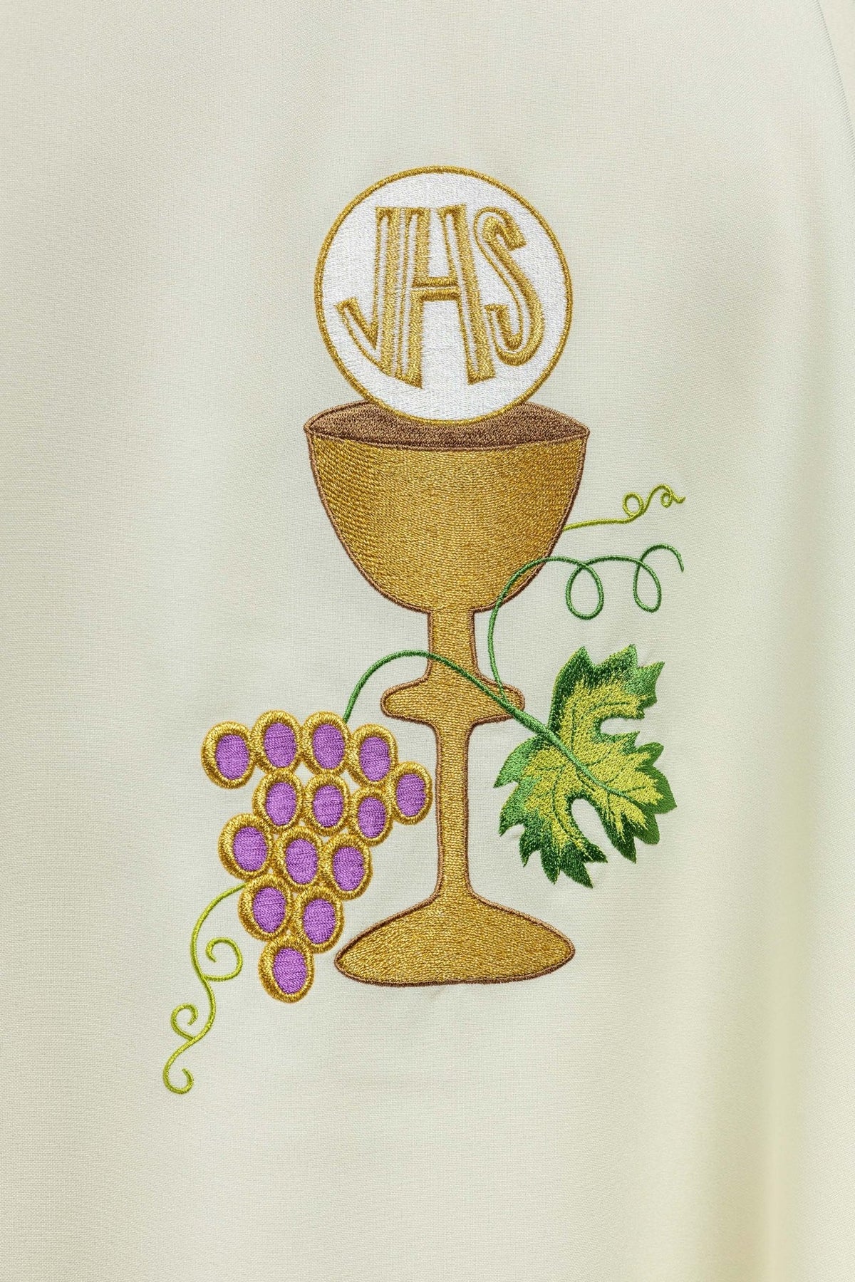 Chasuble close-up showing IHS, gold chalice, purple grapes and green leaf embroidery