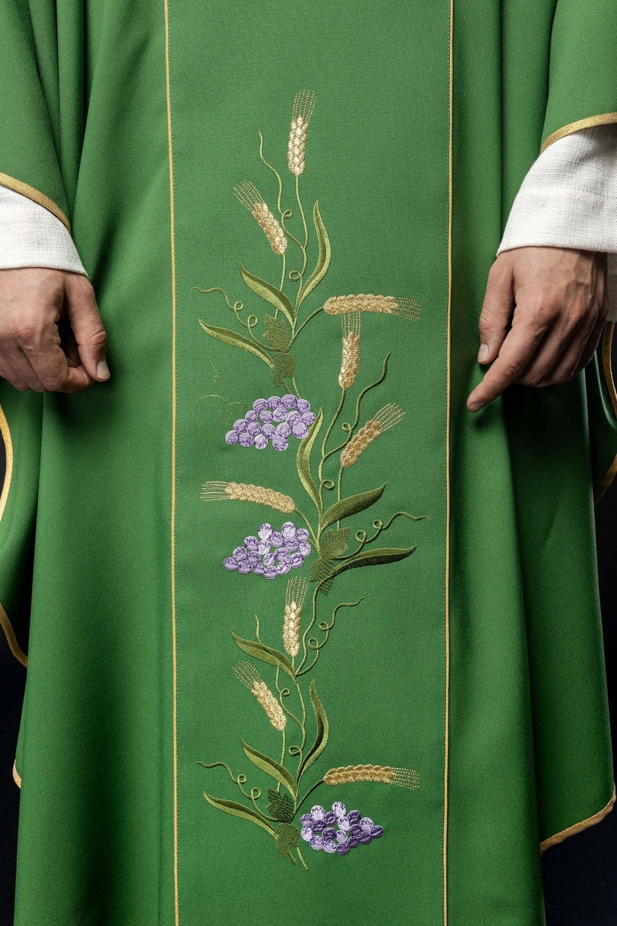 Green chasuble close-up showing embroidered wheat and grapes on the gold orphrey