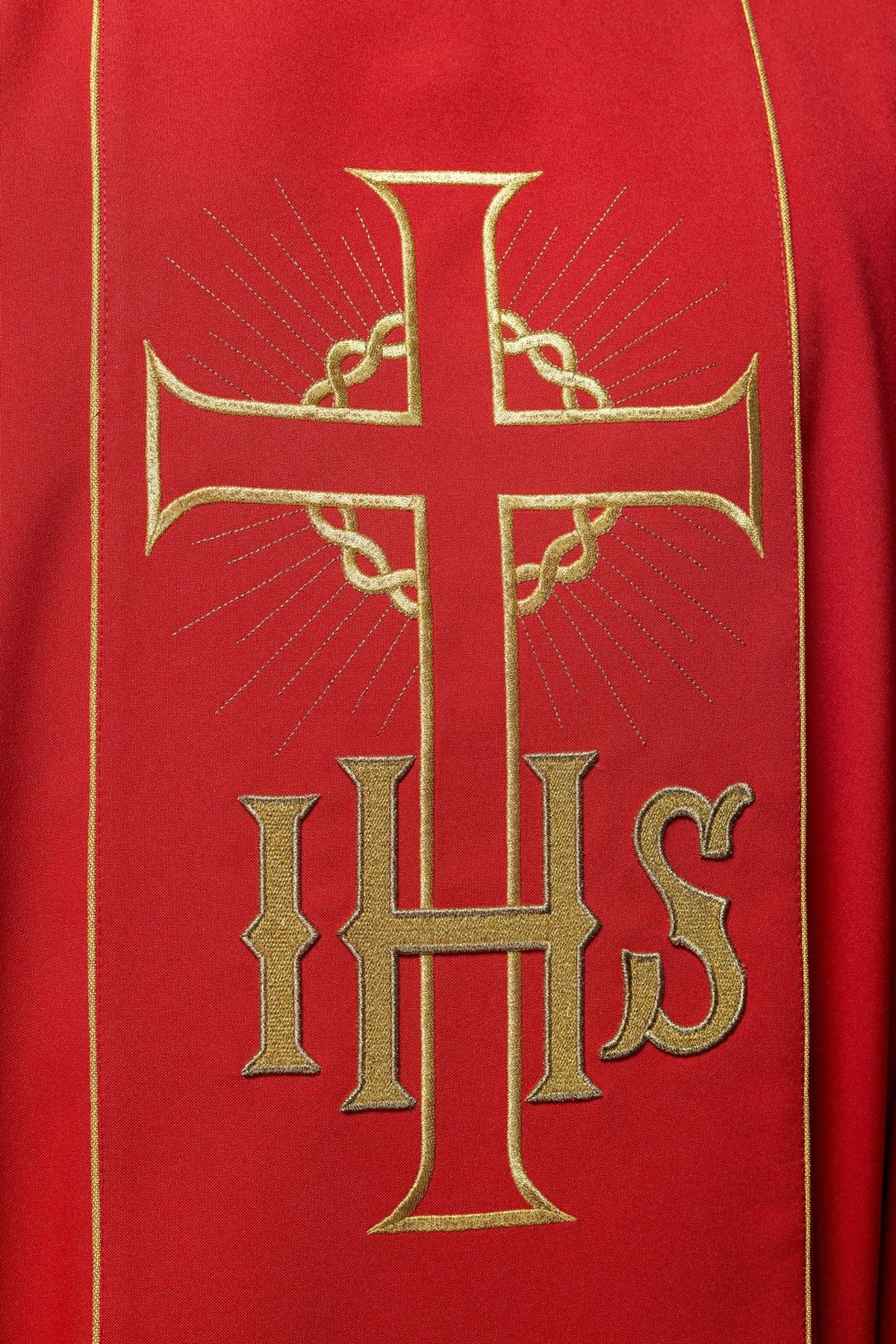Red chasuble close-up of embroidered gold cross and IHS on the orphrey