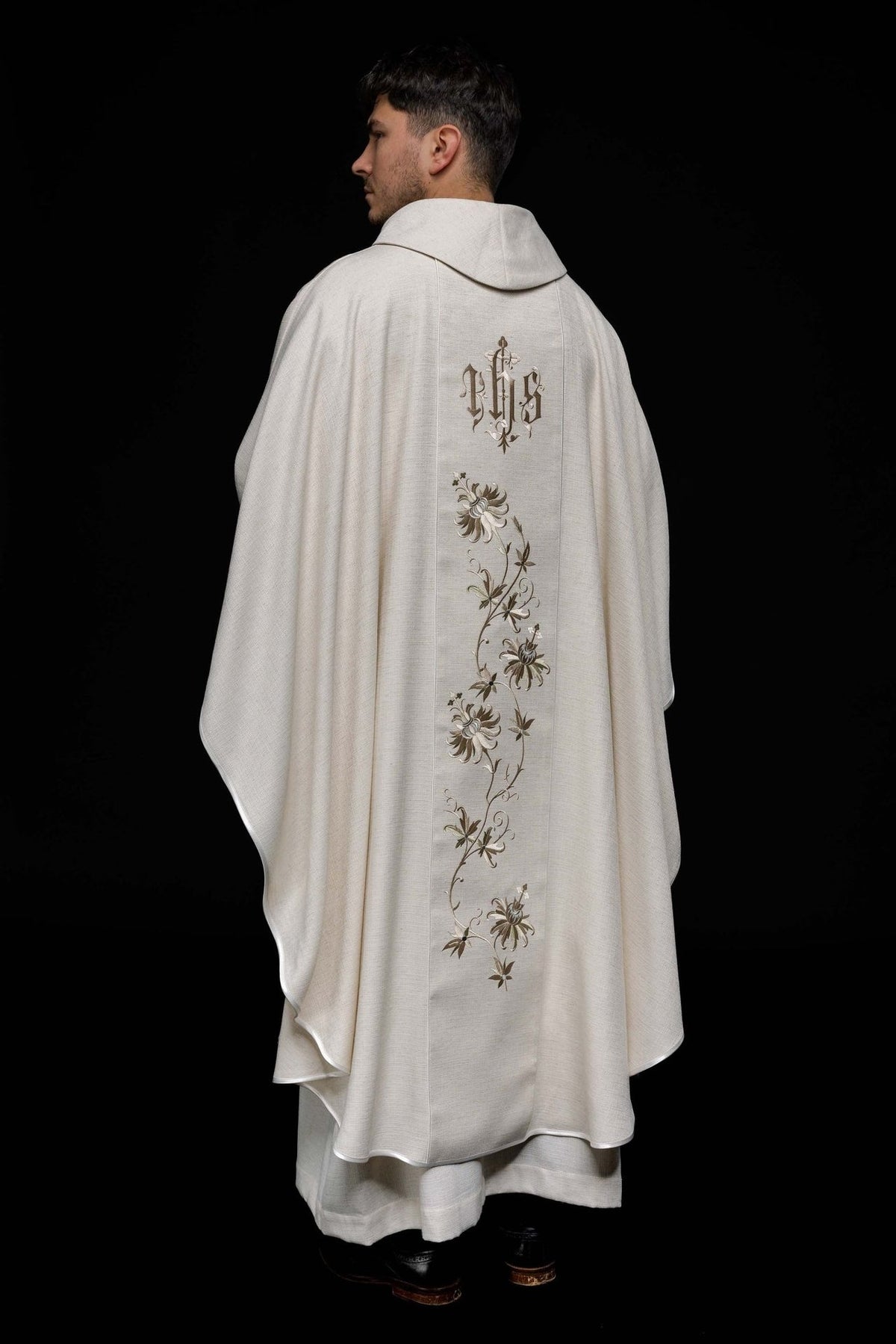 Ecru chasuble back view with embroidered IHS orphrey and floral design