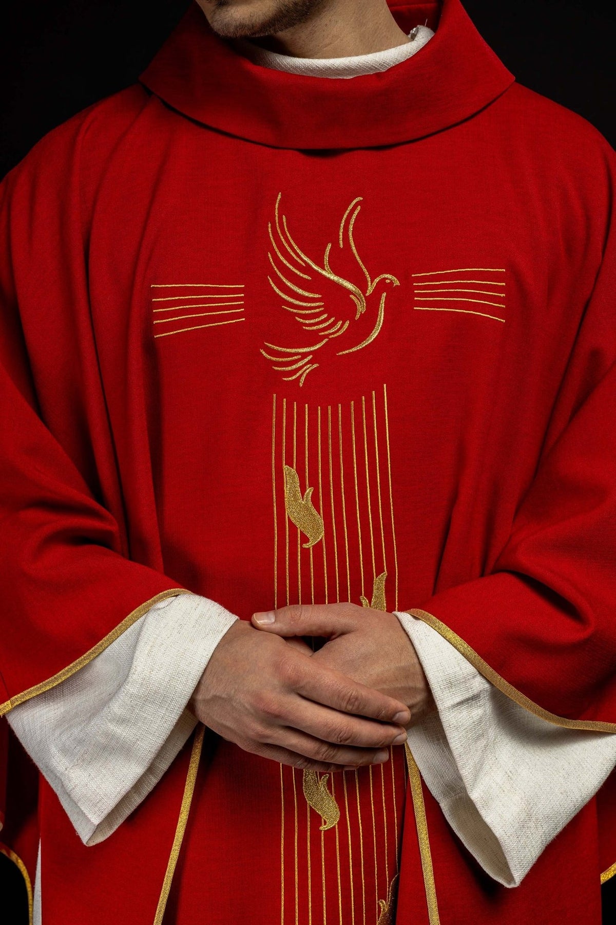 Red chasuble close-up showing stand-up collar and Holy Spirit embroidery