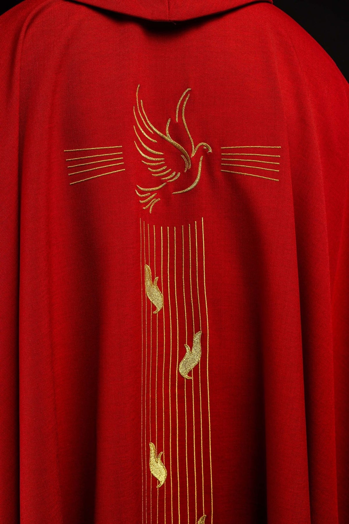 Red chasuble back view with gold trim and Holy Spirit embroidery