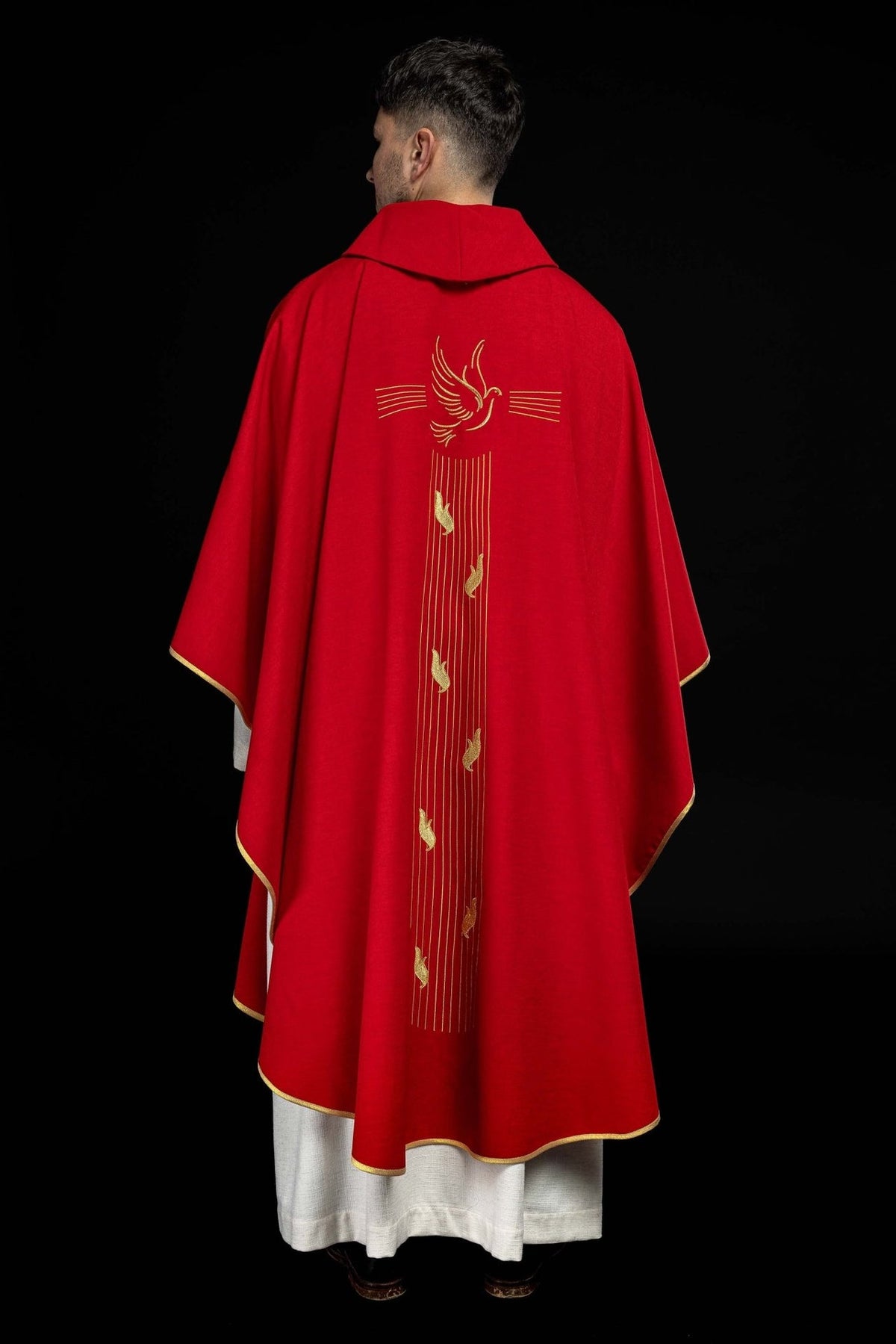 Red chasuble back close-up showing Holy Spirit embroidery and gold lines