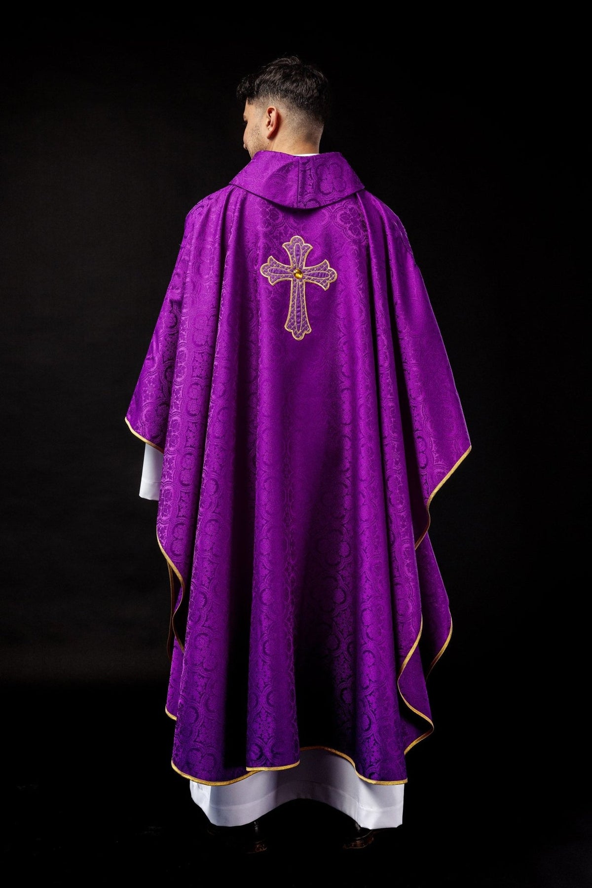 Purple chasuble back view with gold trim and embroidered cross