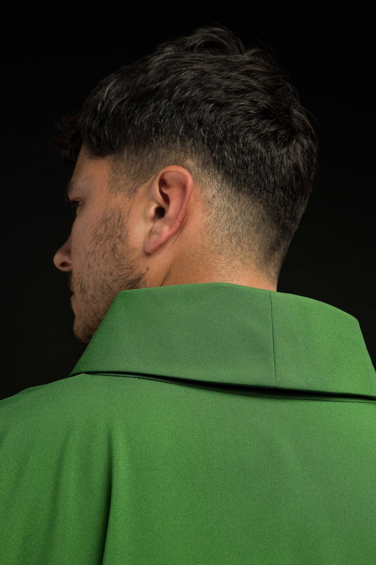 Green chasuble close-up from the back, showing the stand-up collar