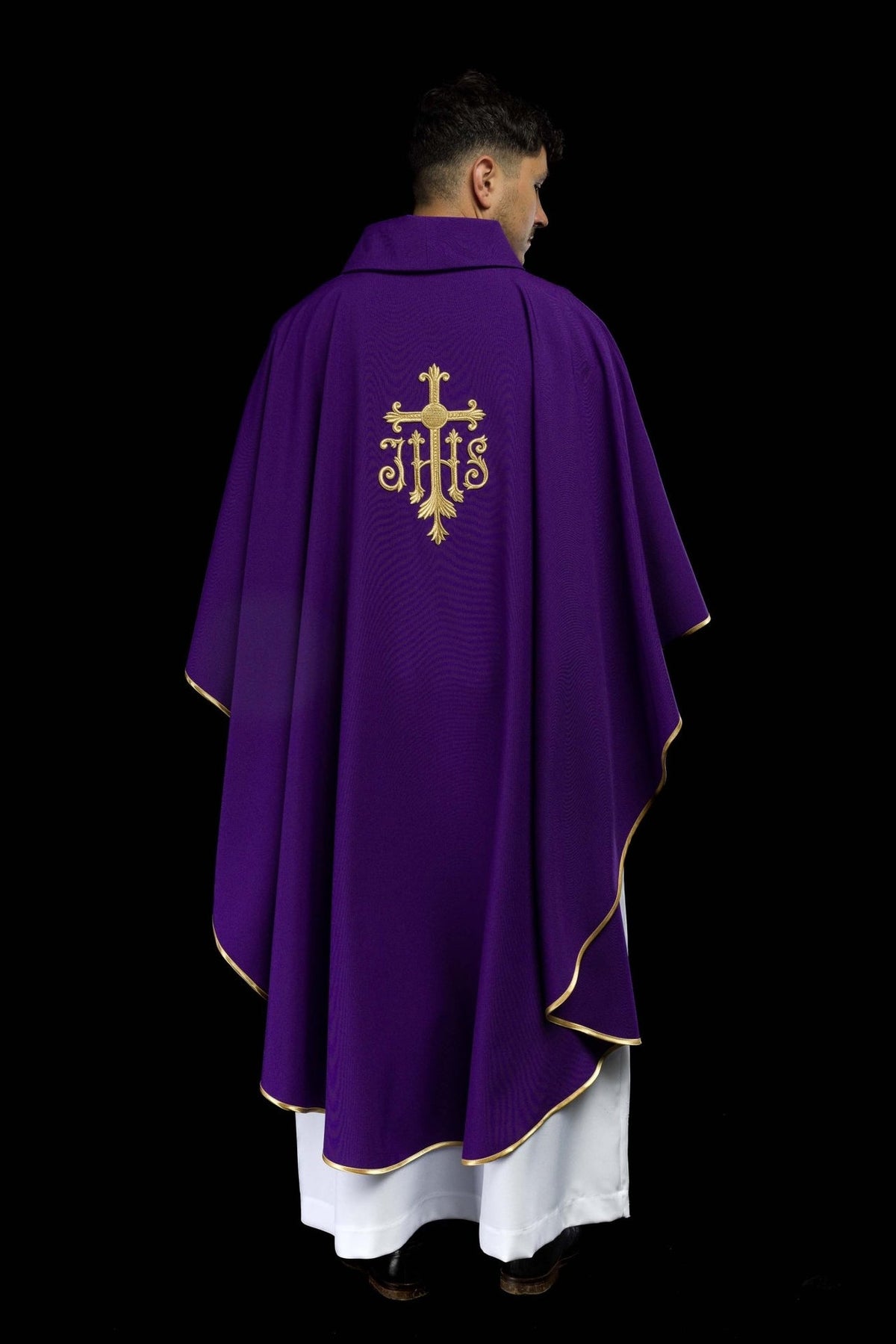 Purple chasuble worn back, showing gold trim and Cross and IHS embroidery