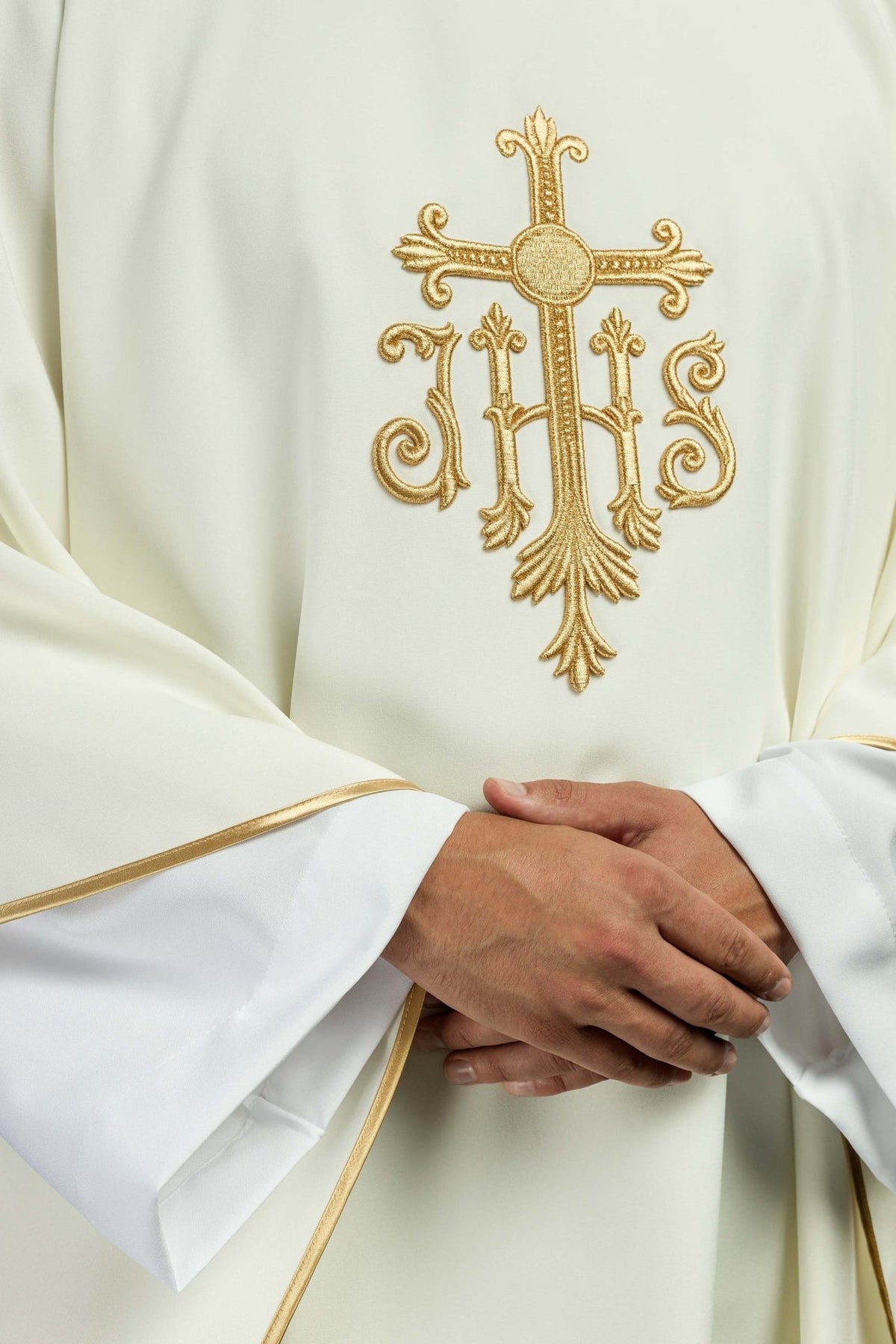 Ecru chasuble front detail with gold embroidery and satin sleeve trim