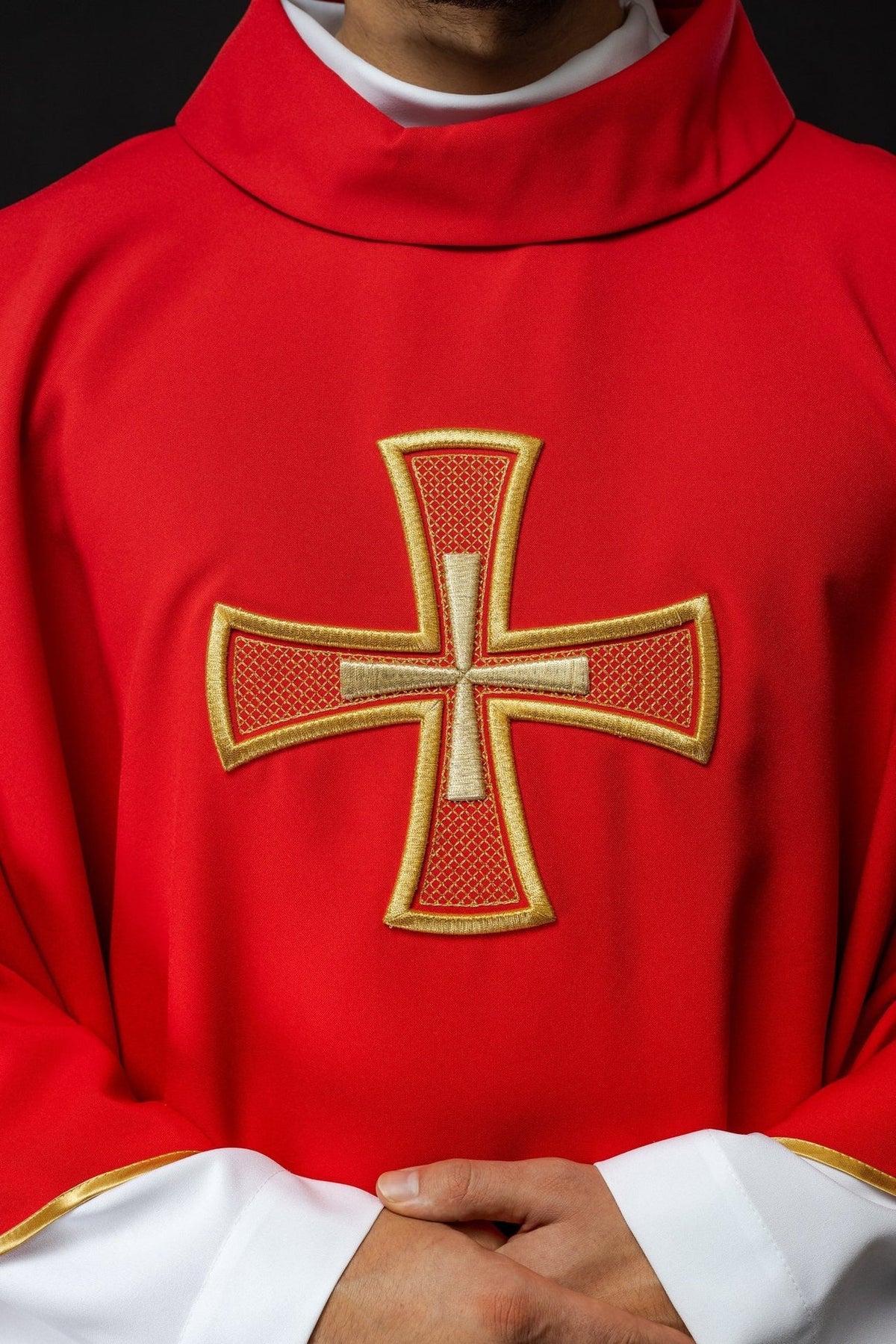 Red chasuble close-up showing gold cross embroidery and stand-up collar