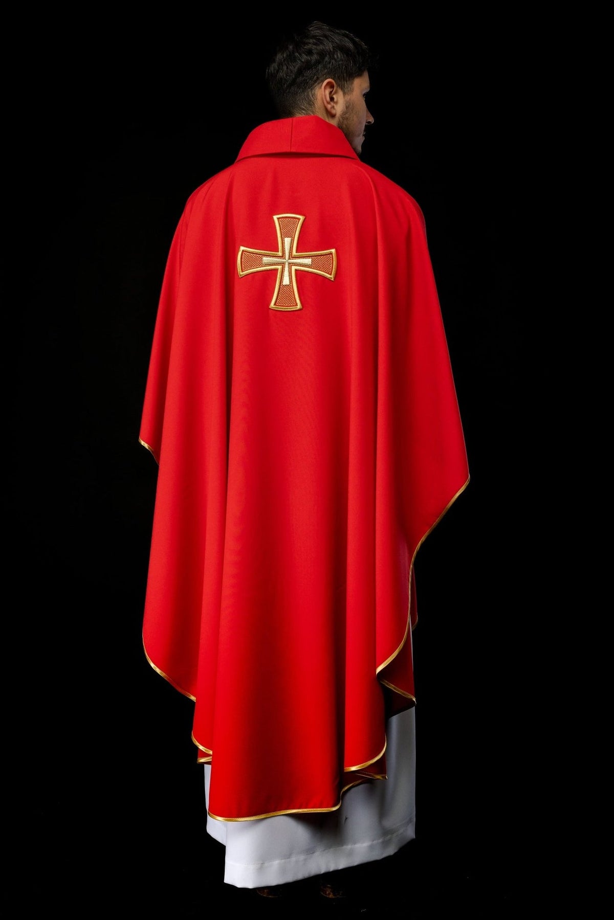 Red chasuble back view with gold embroidered cross and trim