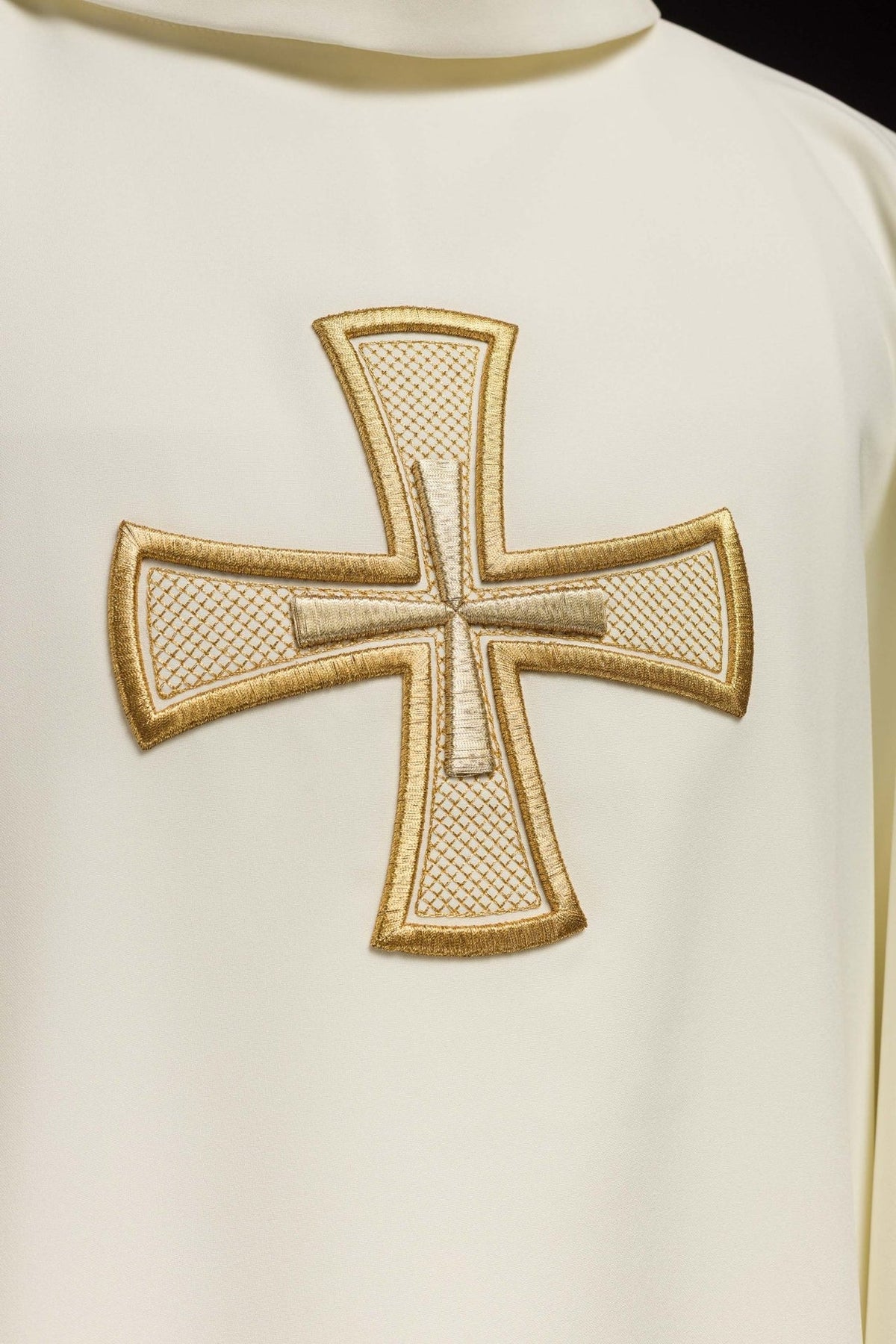 Ecru chasuble close-up showing gold embroidered cross with lattice detail