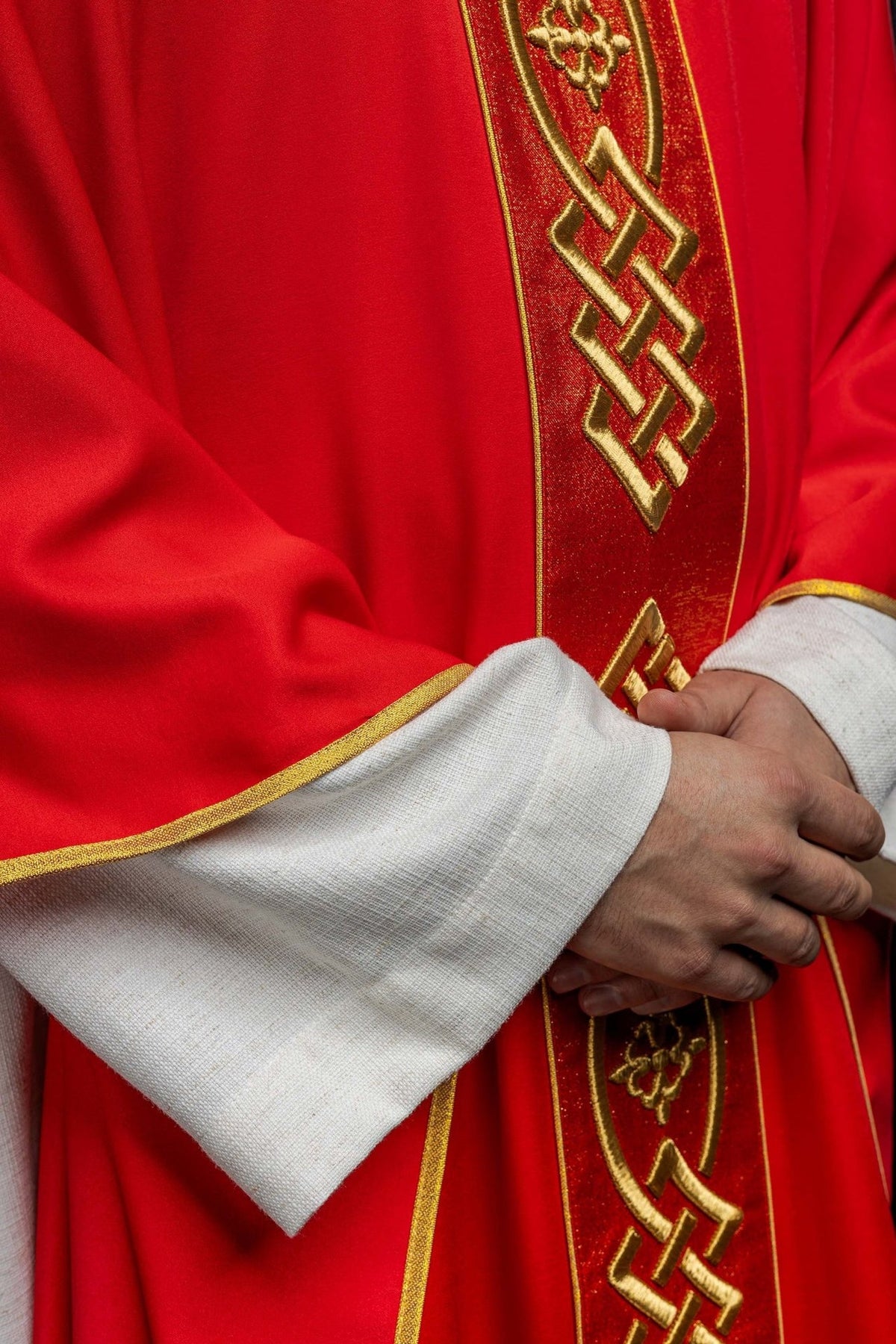 Red chasuble front detail showing gold trim, embroidered panel and red fabric
